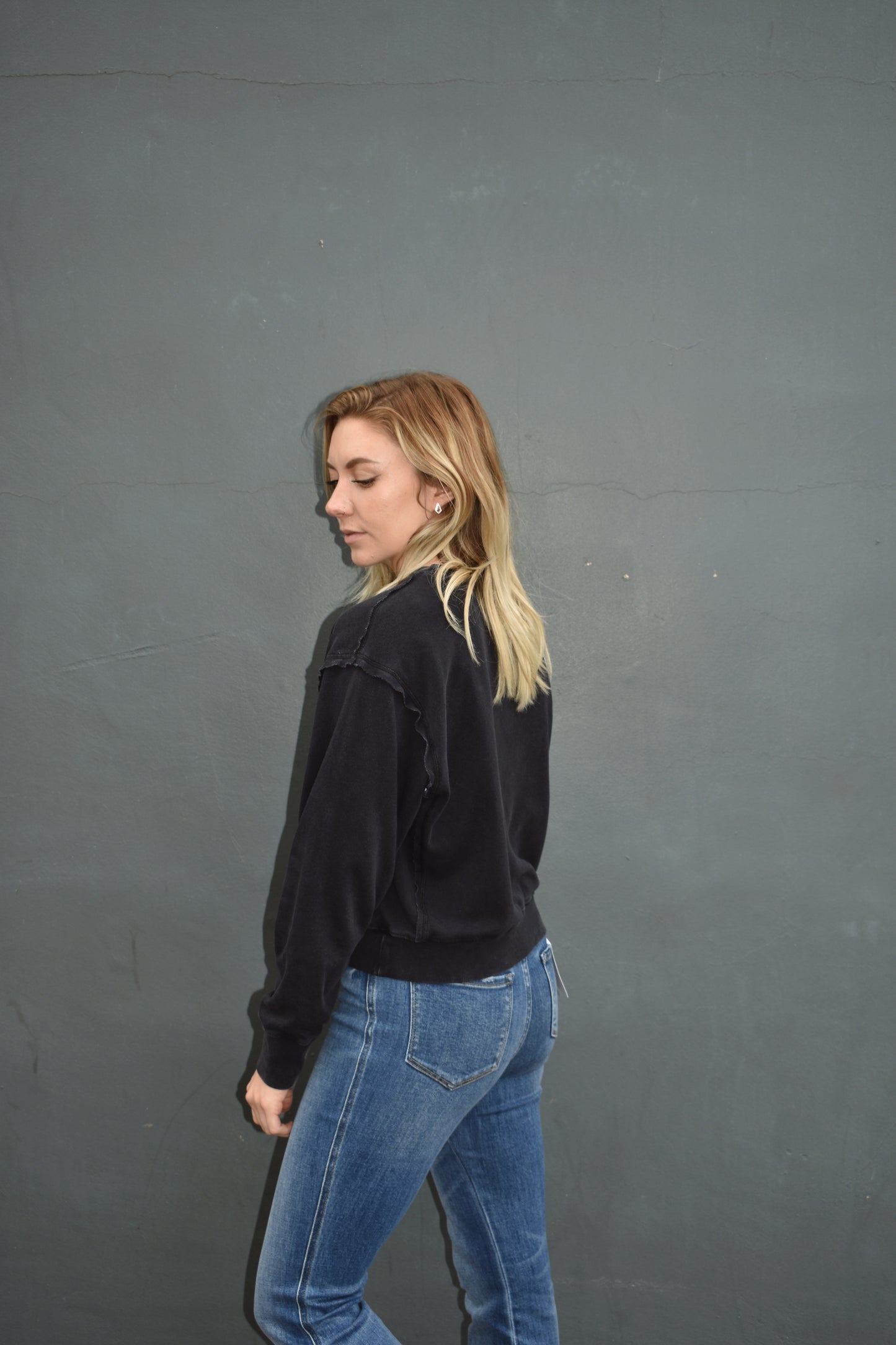 black drop shoulder full length sweatshirt, no hood, raw hem edge detail, ribbed cuffs