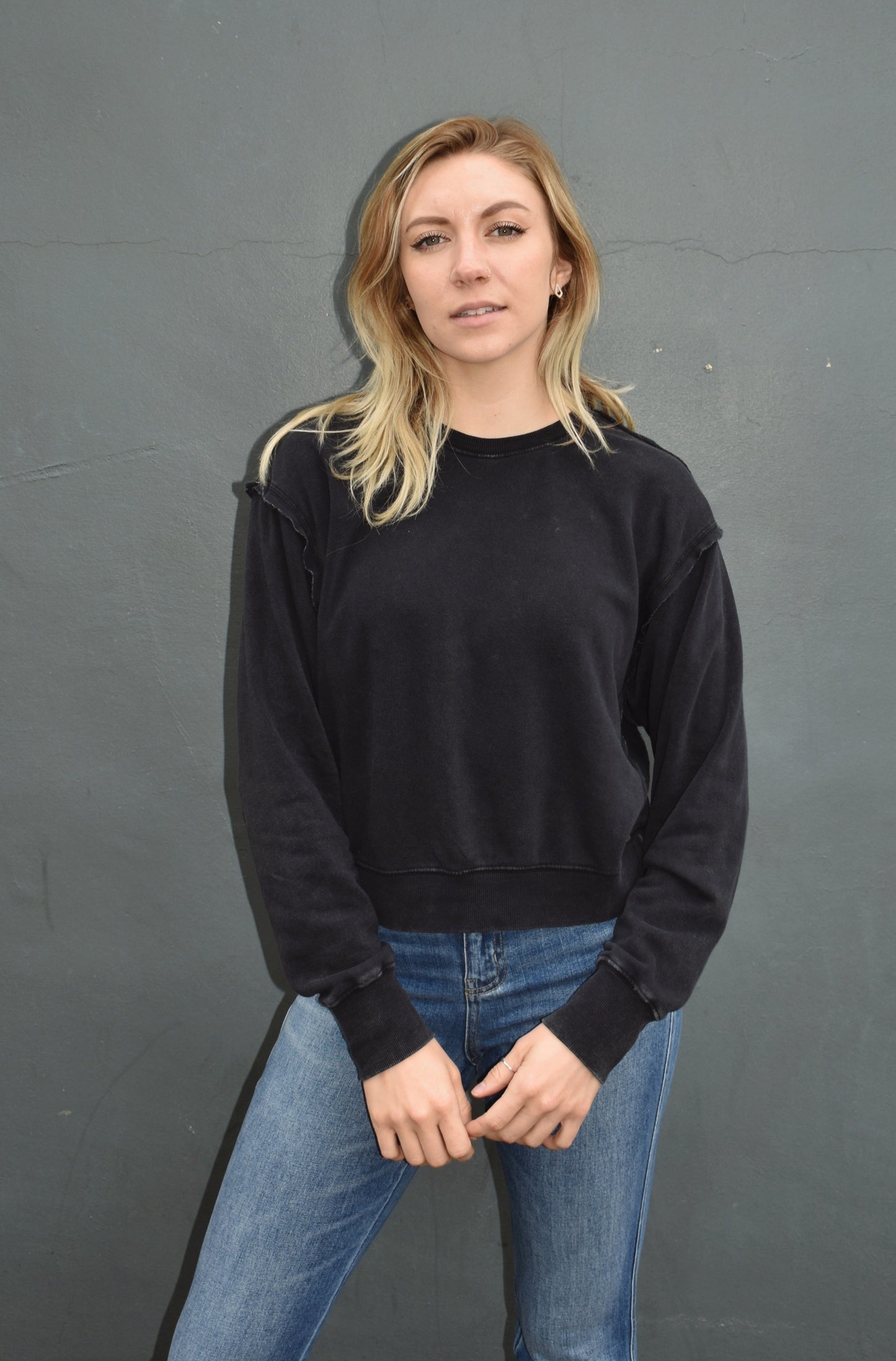 black drop shoulder full length sweatshirt, no hood, raw hem edge detail, ribbed cuffs