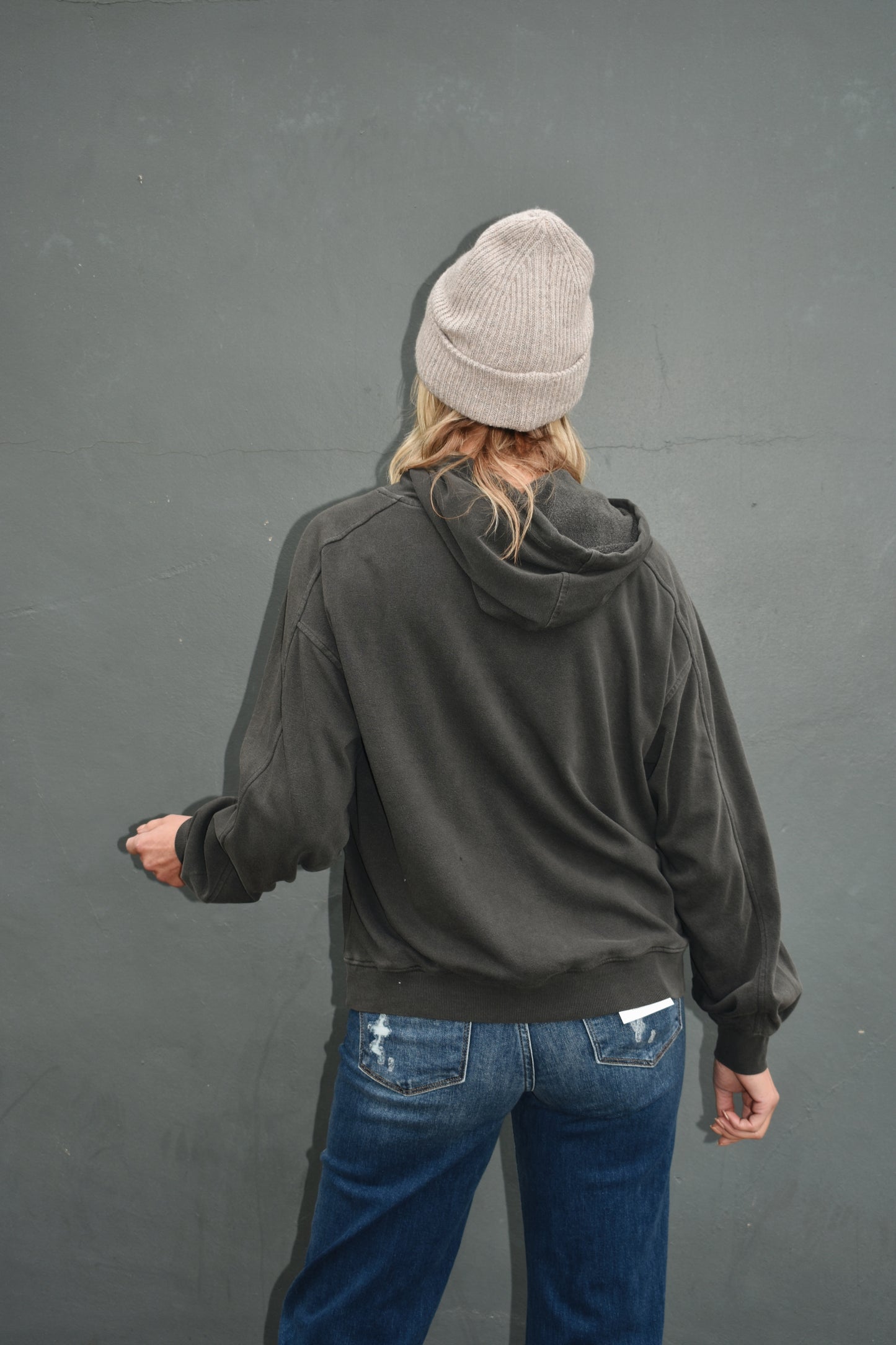 Black full length hoodie with drop shoulders, drawstrings, and ribbed cuffs. loose fitting.