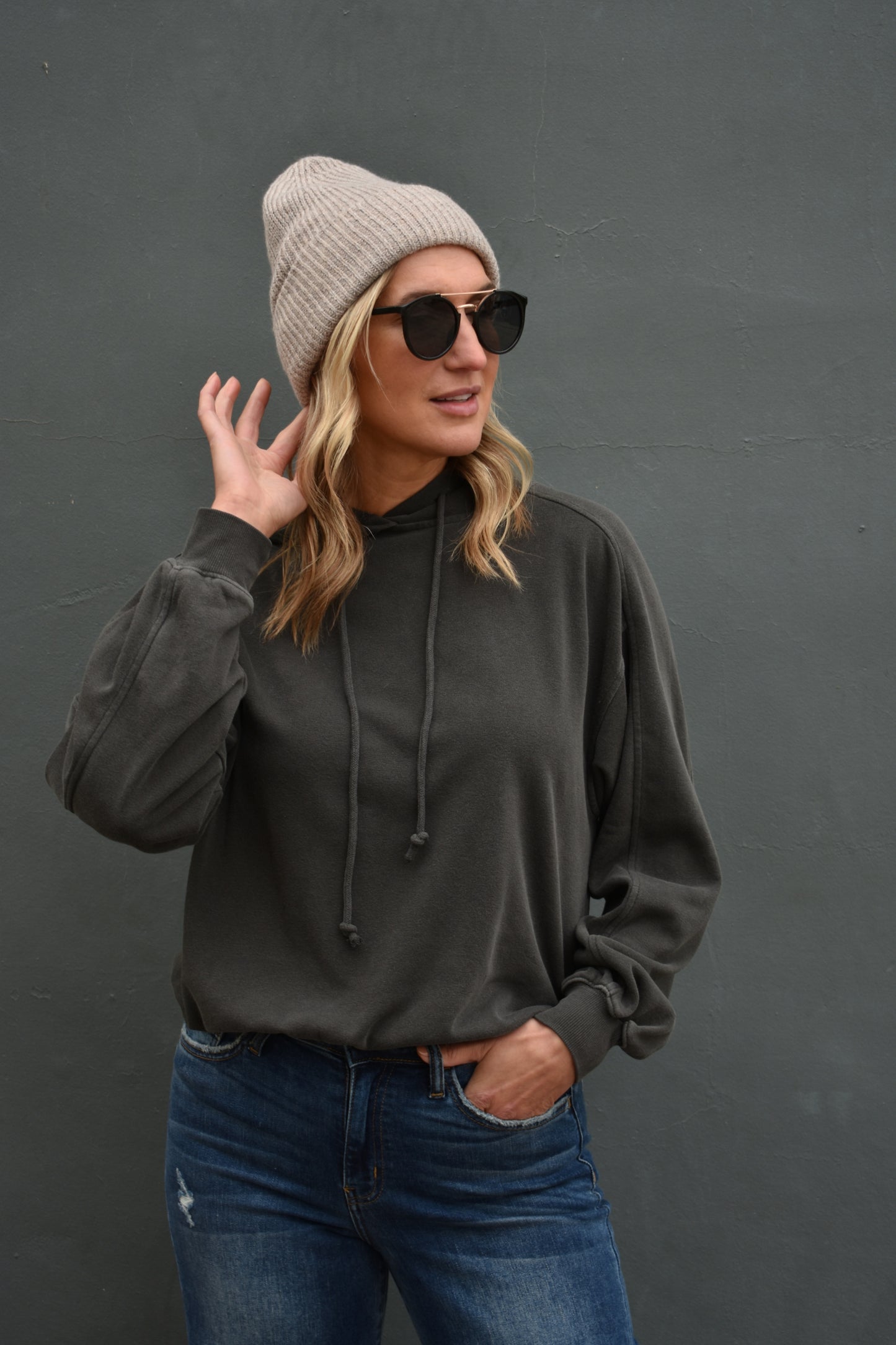 Black full length hoodie with drop shoulders, drawstrings, and ribbed cuffs. loose fitting.