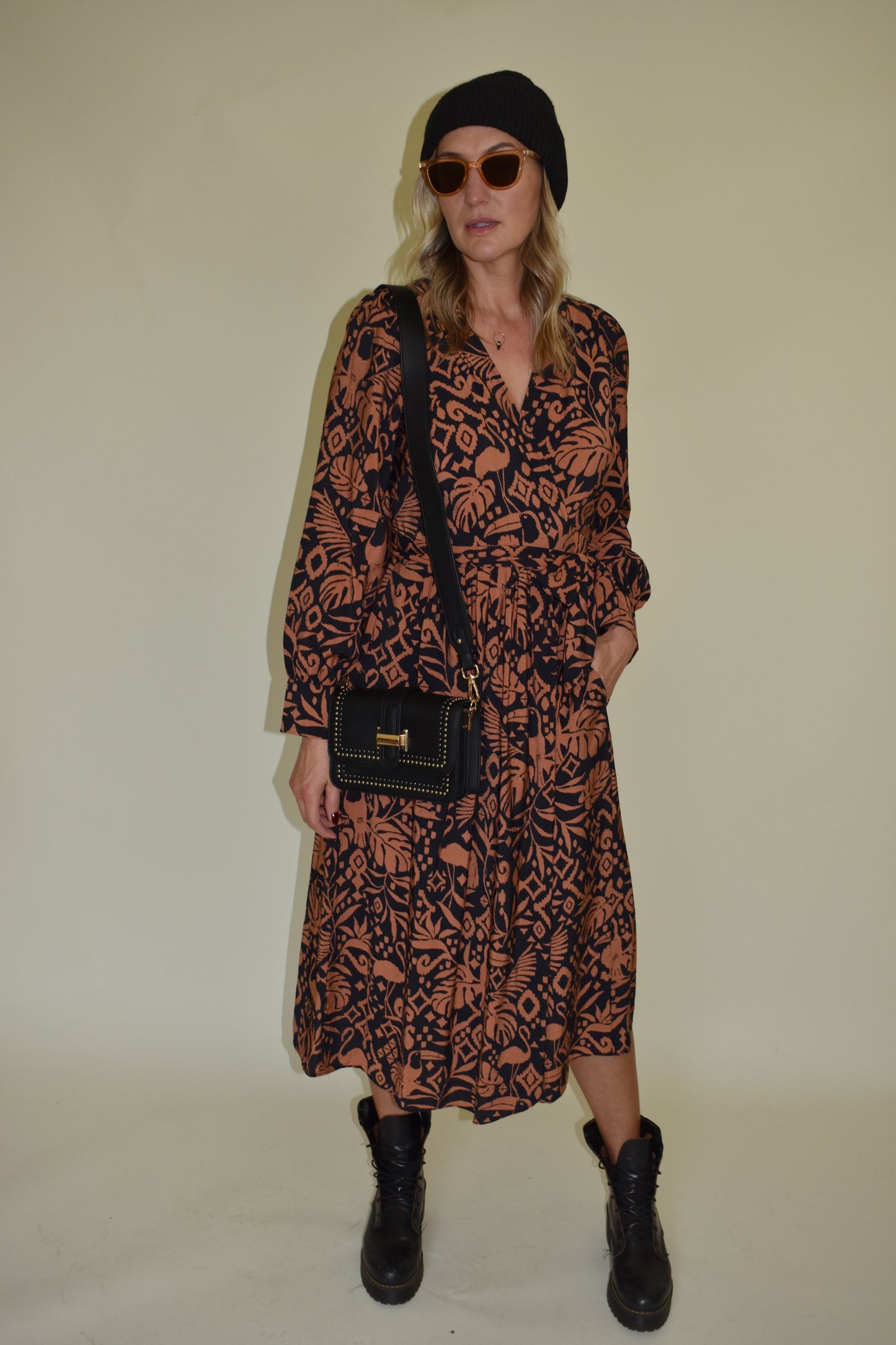 Monstera print wrap midi dress with long bishop sleeves black and clay color