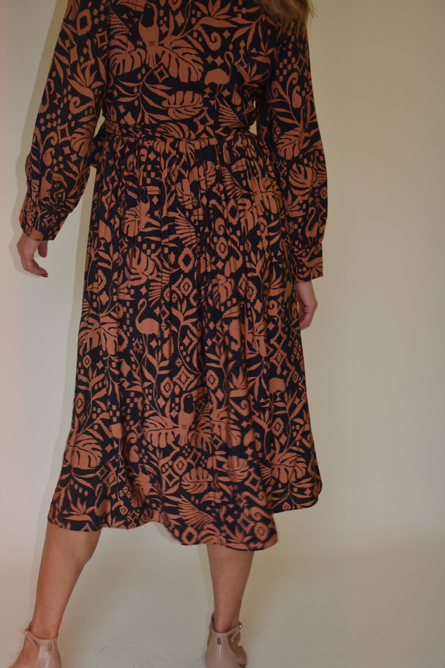 Monstera print wrap midi dress with long bishop sleeves black and clay color