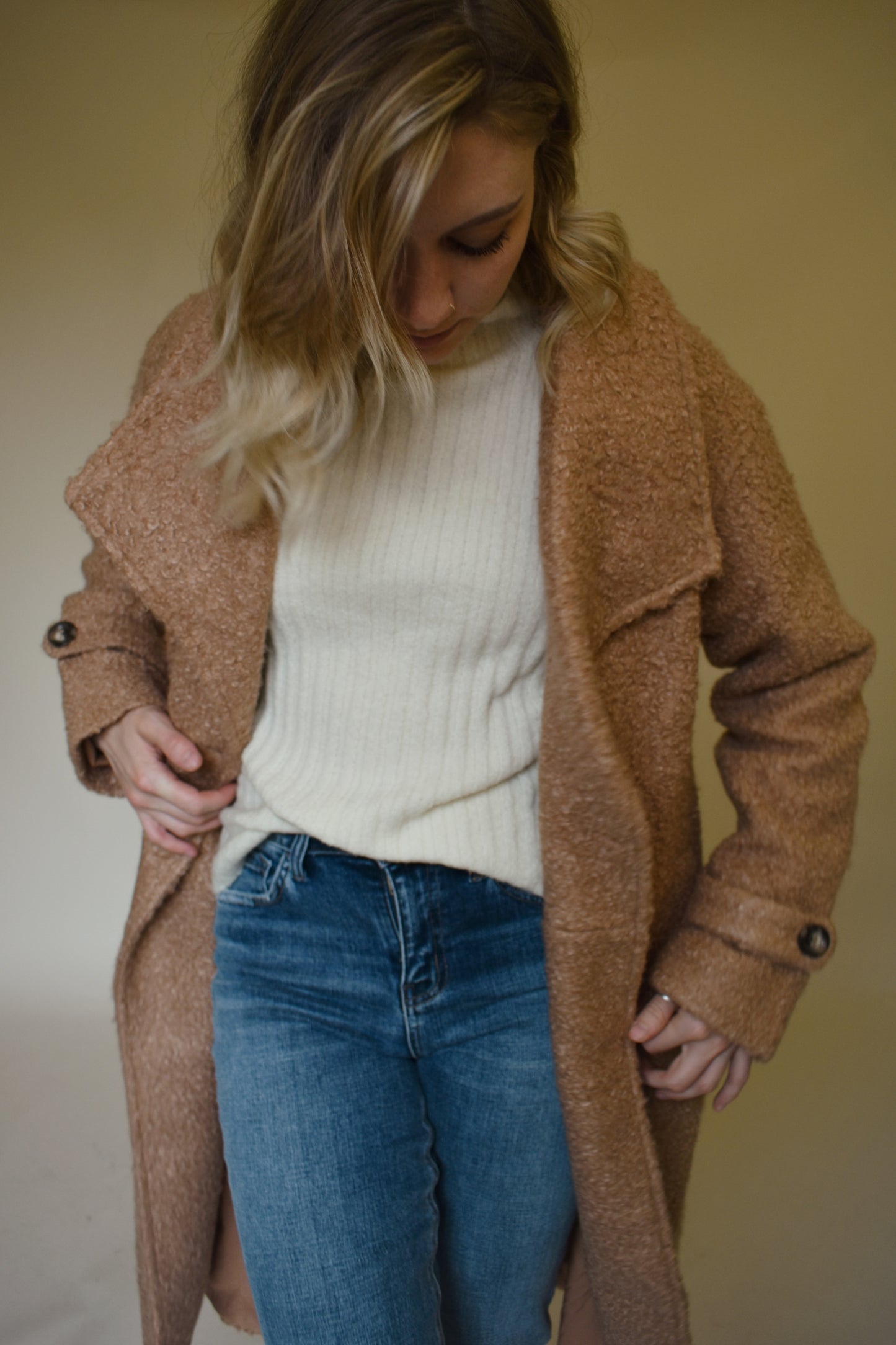 Teddy trench coat in camel with waterfall collar and belt loops with tie, double button closure, long sleeves come fitted with toggle buttons, slit back hem, pockets
