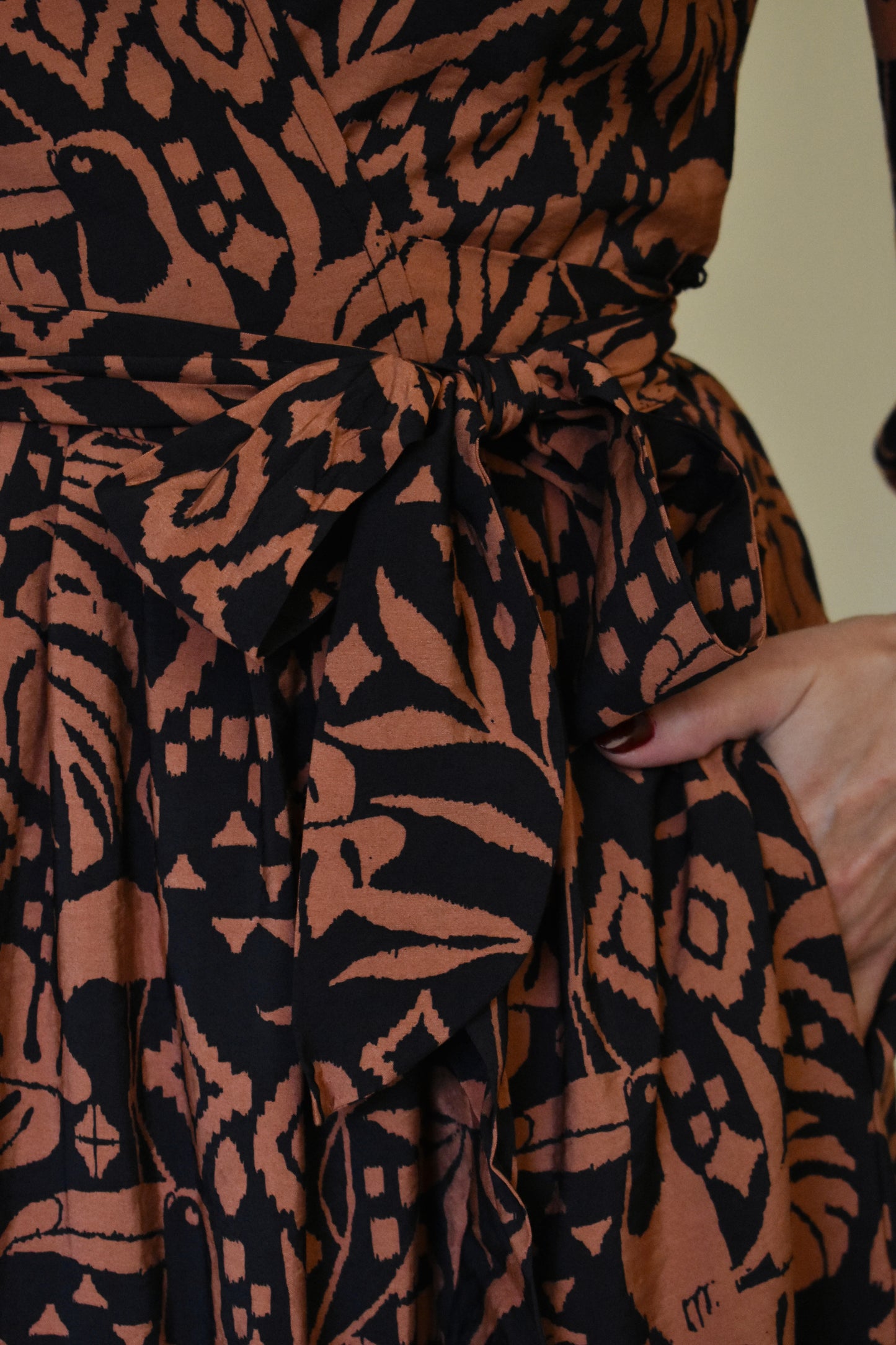 Monstera print wrap midi dress with long bishop sleeves black and clay color