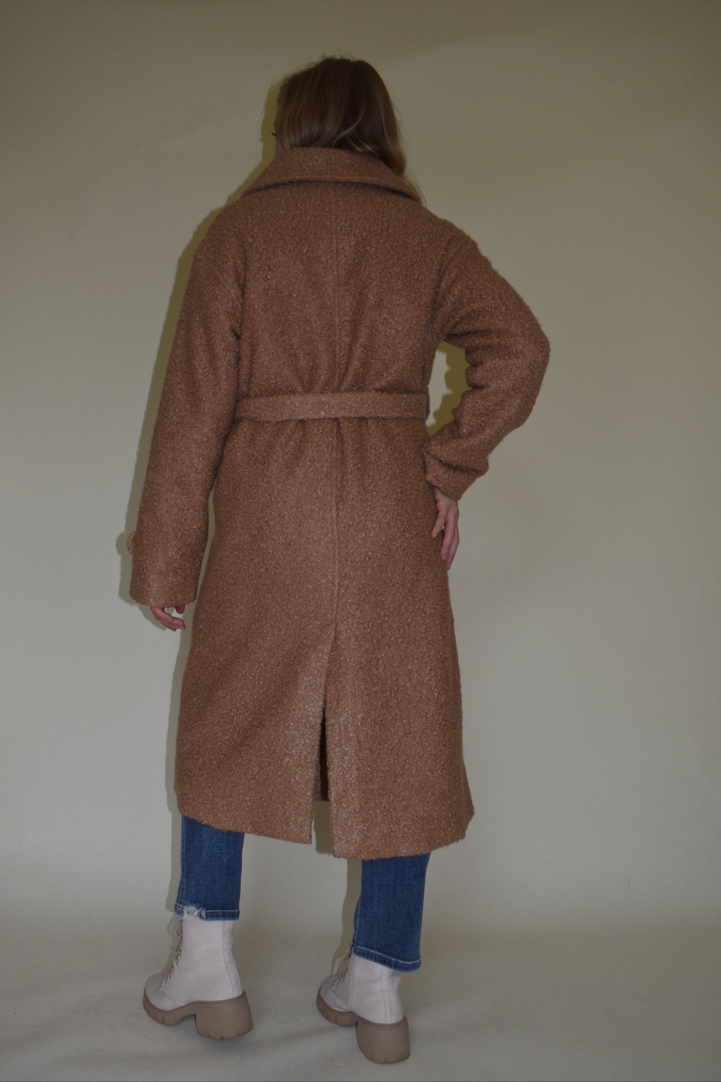 Teddy trench coat in camel with waterfall collar and belt loops with tie, double button closure, long sleeves come fitted with toggle buttons, slit back hem, pockets