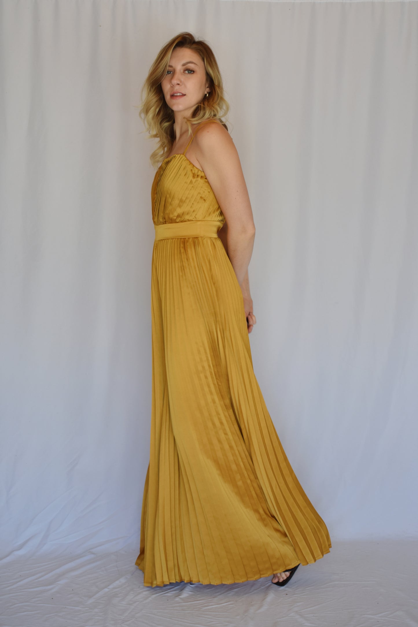 marigold satin pleated extra wide leg jumpsuit with spaghetti straps and band at waist with hidden zipper enclosure of back straight across neckline