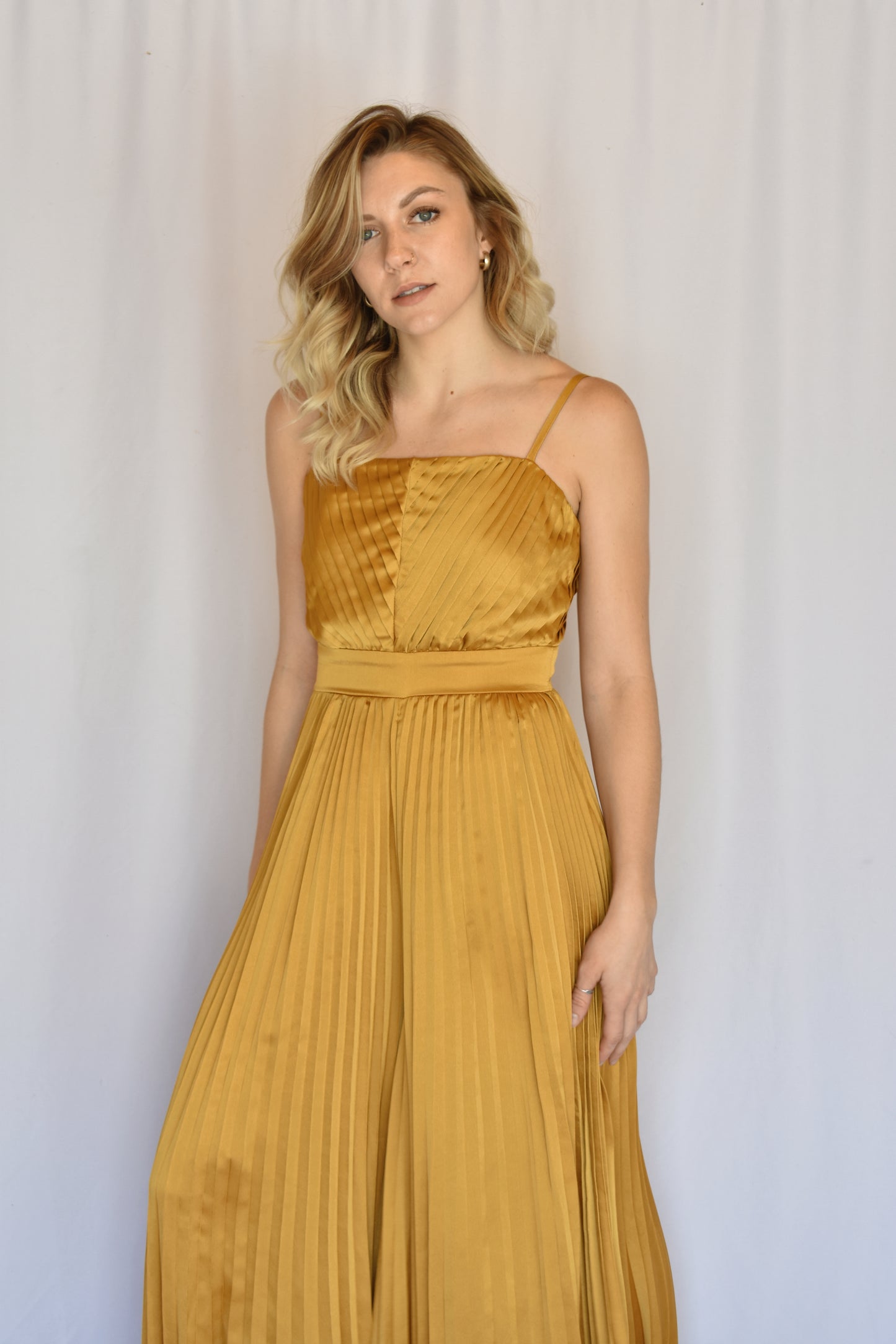 marigold satin pleated extra wide leg jumpsuit with spaghetti straps and band at waist with hidden zipper enclosure of back straight across neckline