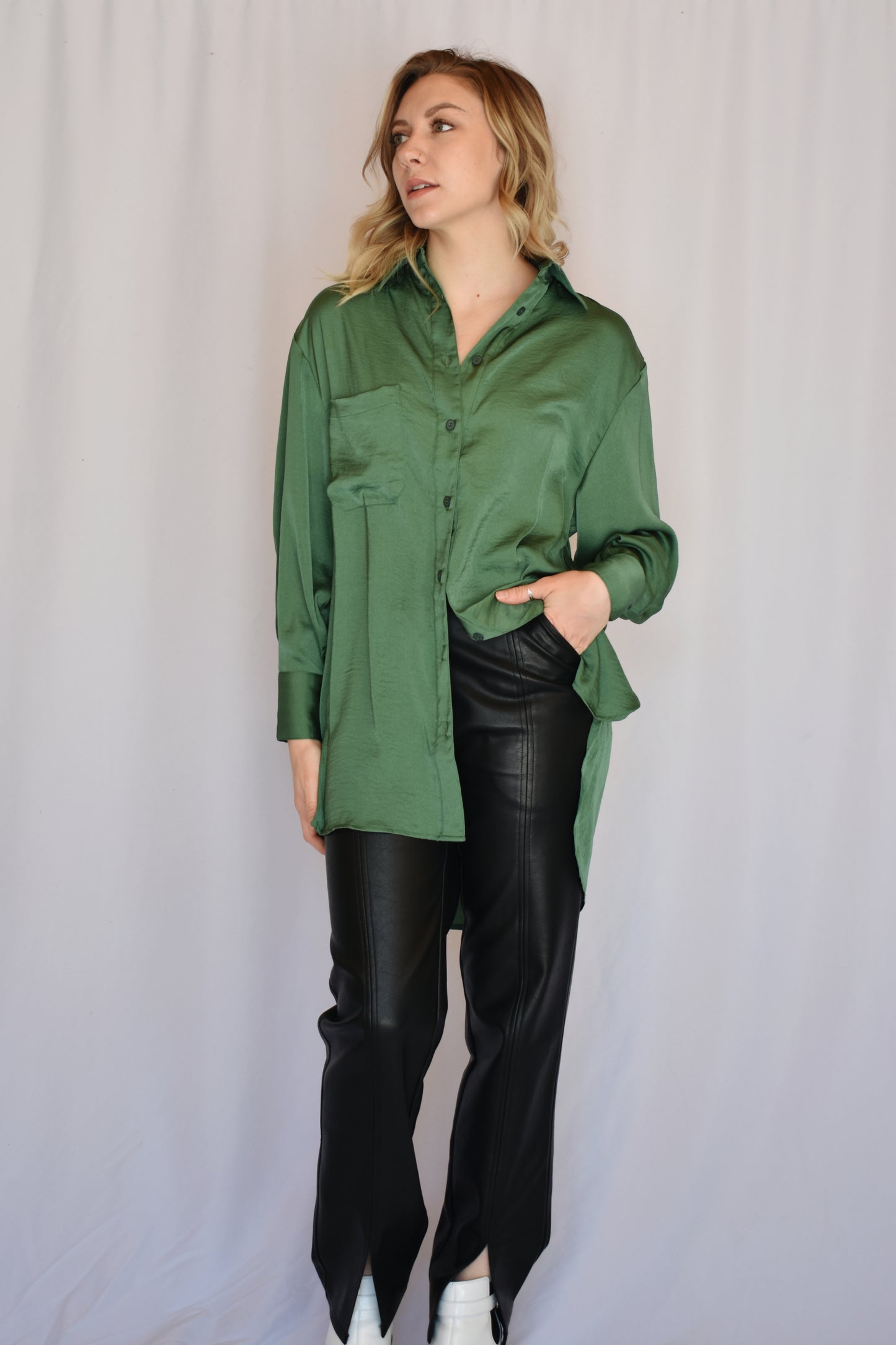 button down satin green tunic with button cuffs and one breast pocket and drop shoulders. Relaxed fit.