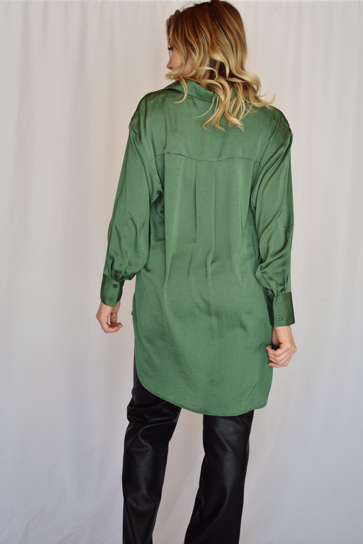 button down satin green tunic with button cuffs and one breast pocket and drop shoulders. Relaxed fit.