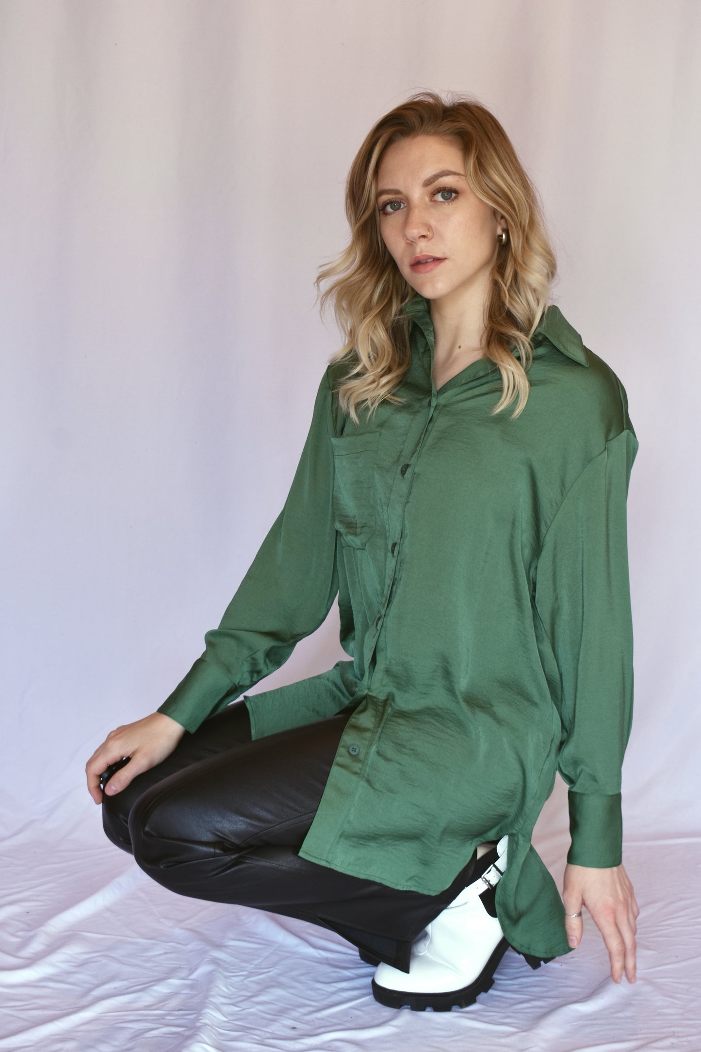 button down satin green tunic with button cuffs and one breast pocket and drop shoulders. Relaxed fit.