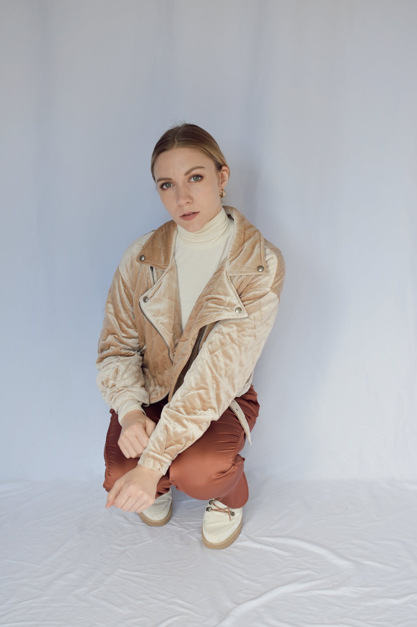 quilted velvet moto jacket with pockets and one small diagonal zip pocket on shoulder. Removable belt at bottom. silver snap button on cuffs and tip of collar. Relaxed fit.