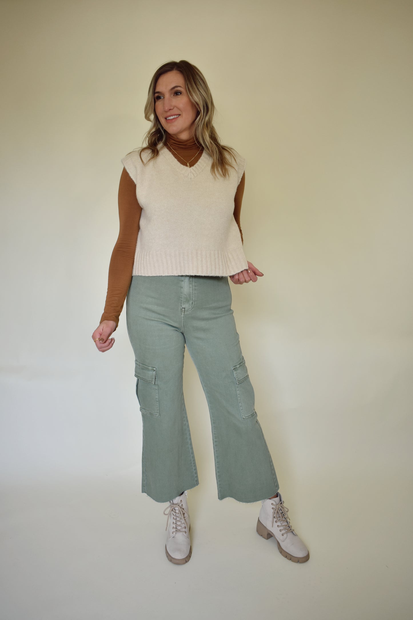 V neck sweater vest - slightly cropped, loose fit. Wide ribbed detail on neckline, sleeves and hem. Cream colored.