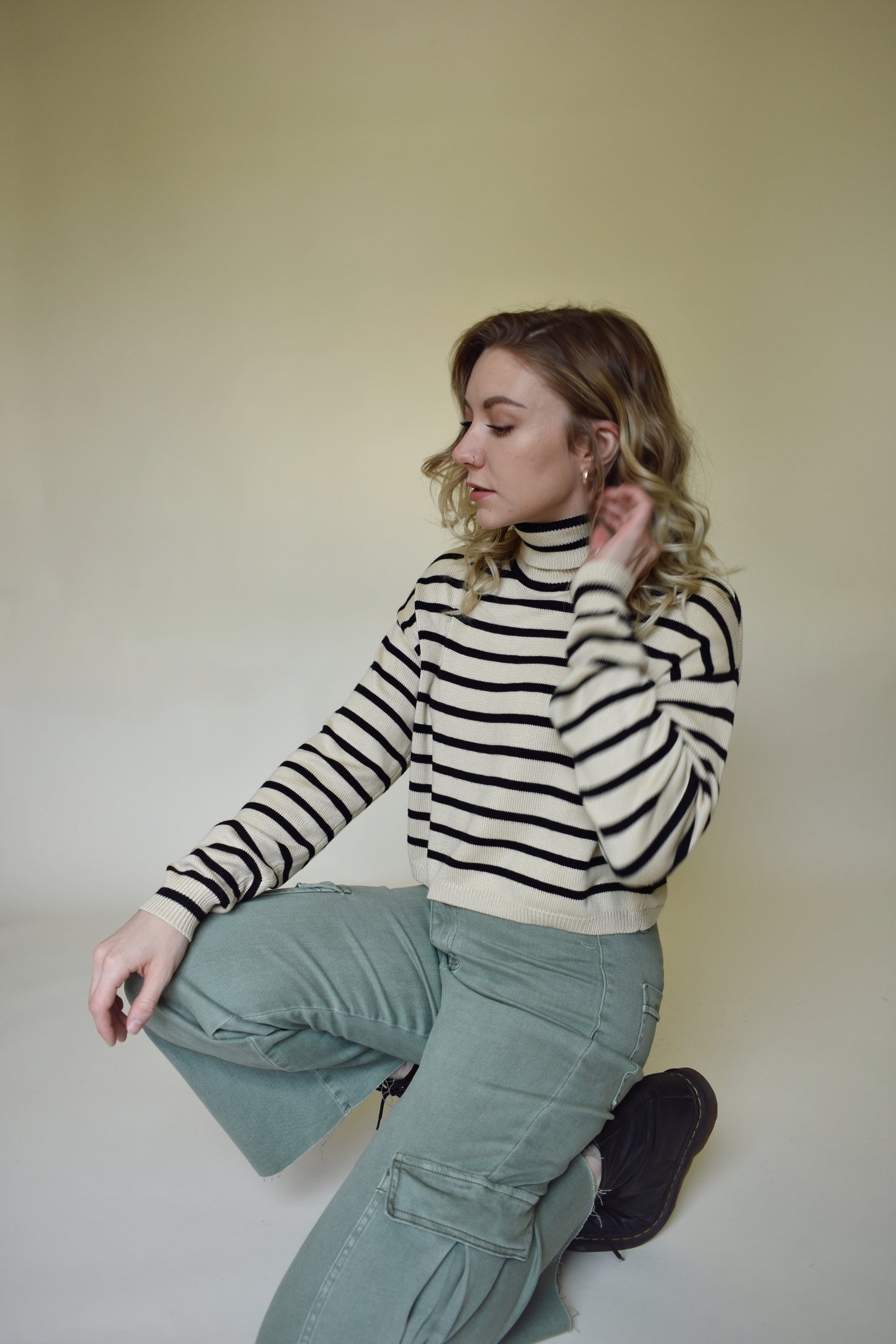 Wide leg cargo pants with pockets on side with flap and on the back. Button enclosure with belt loops. Raw hem. Sage green color.