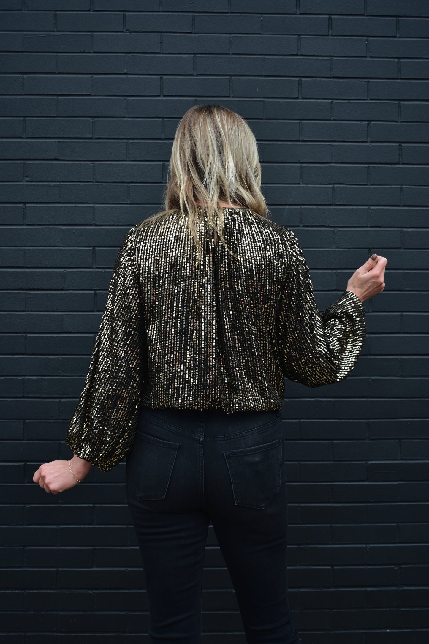 black long sleeve blouse with full gold sequins, balloon sleeves with elasticised waist, loose fit, crew neck with back button enclosure on neck.