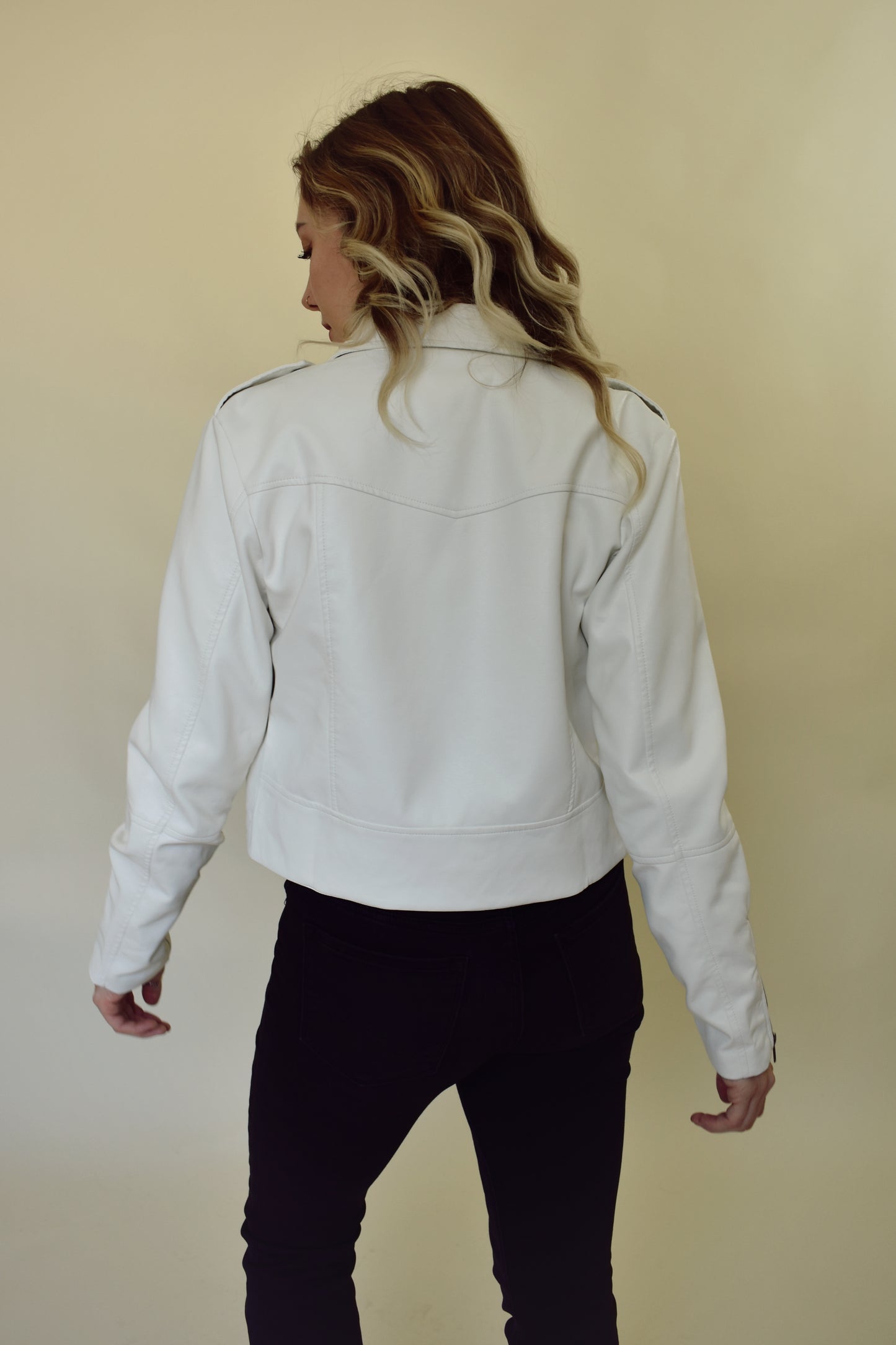 vegan leather moto jacket with diagonal front zip, front pockets, zippers on sleeves and snap details on collar and shoulders