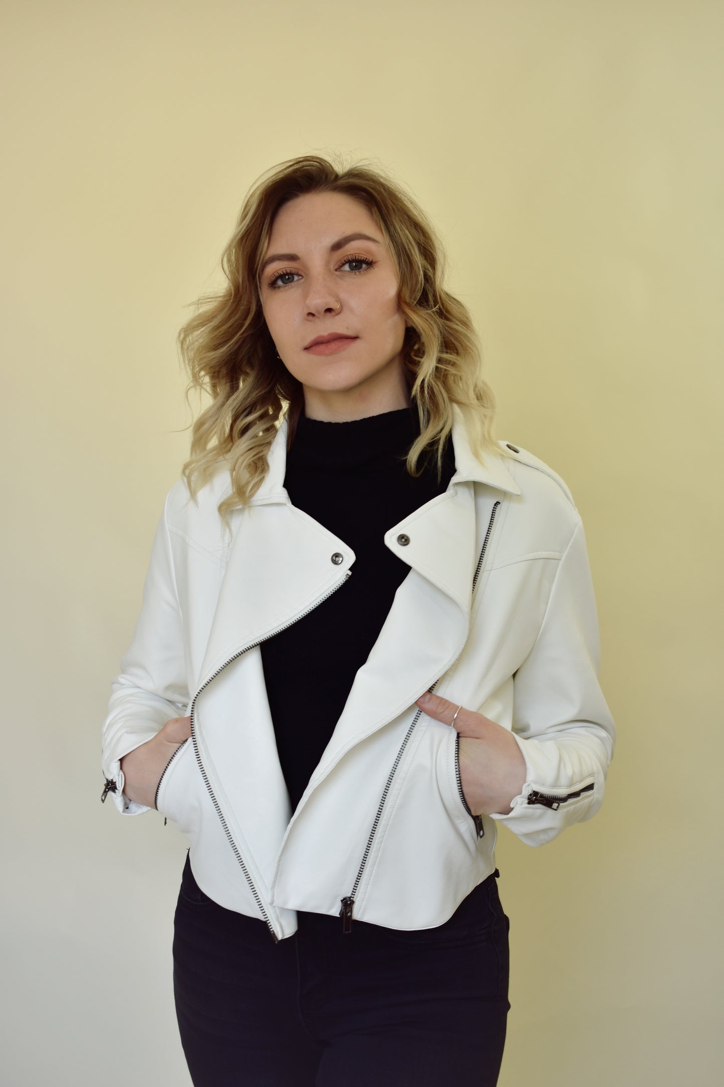 vegan leather moto jacket with diagonal front zip, front pockets, zippers on sleeves and snap details on collar and shoulders