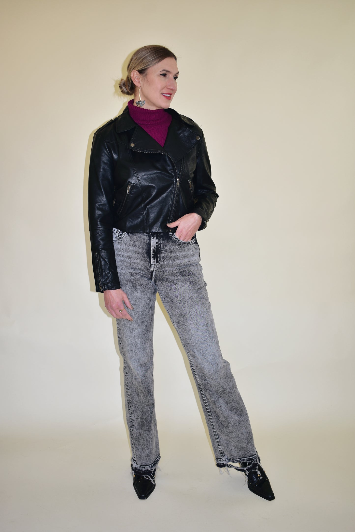 vegan leather moto jacket with diagonal front zip, front pockets, zippers on sleeves and snap details on collar and shoulders