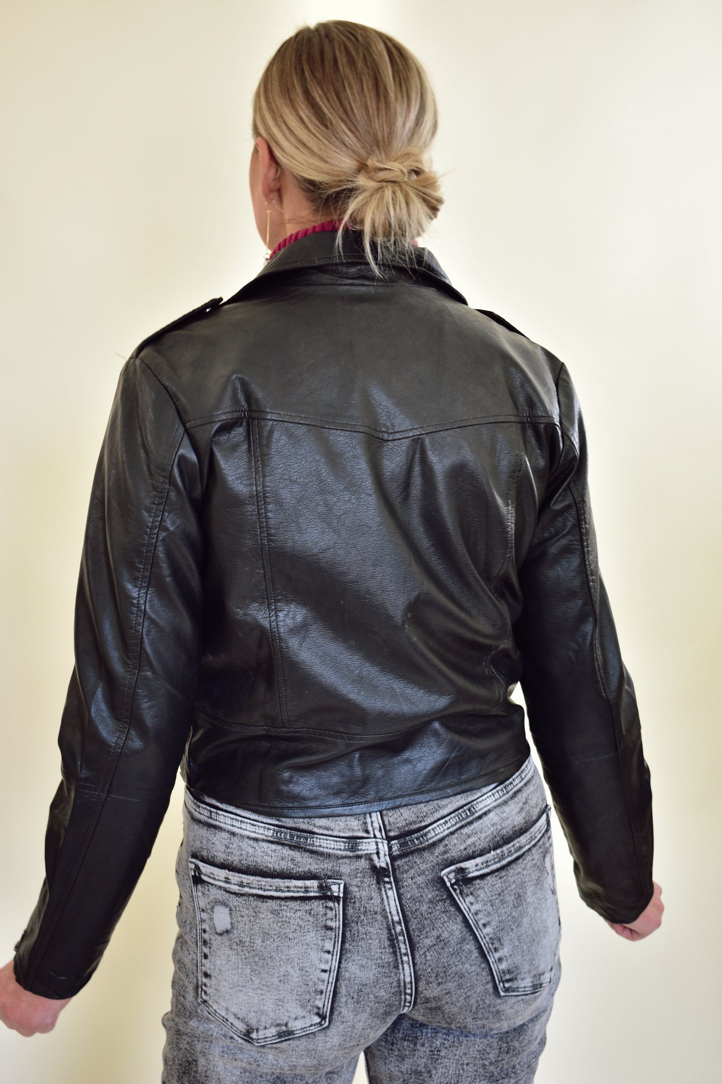 vegan leather moto jacket with diagonal front zip, front pockets, zippers on sleeves and snap details on collar and shoulders