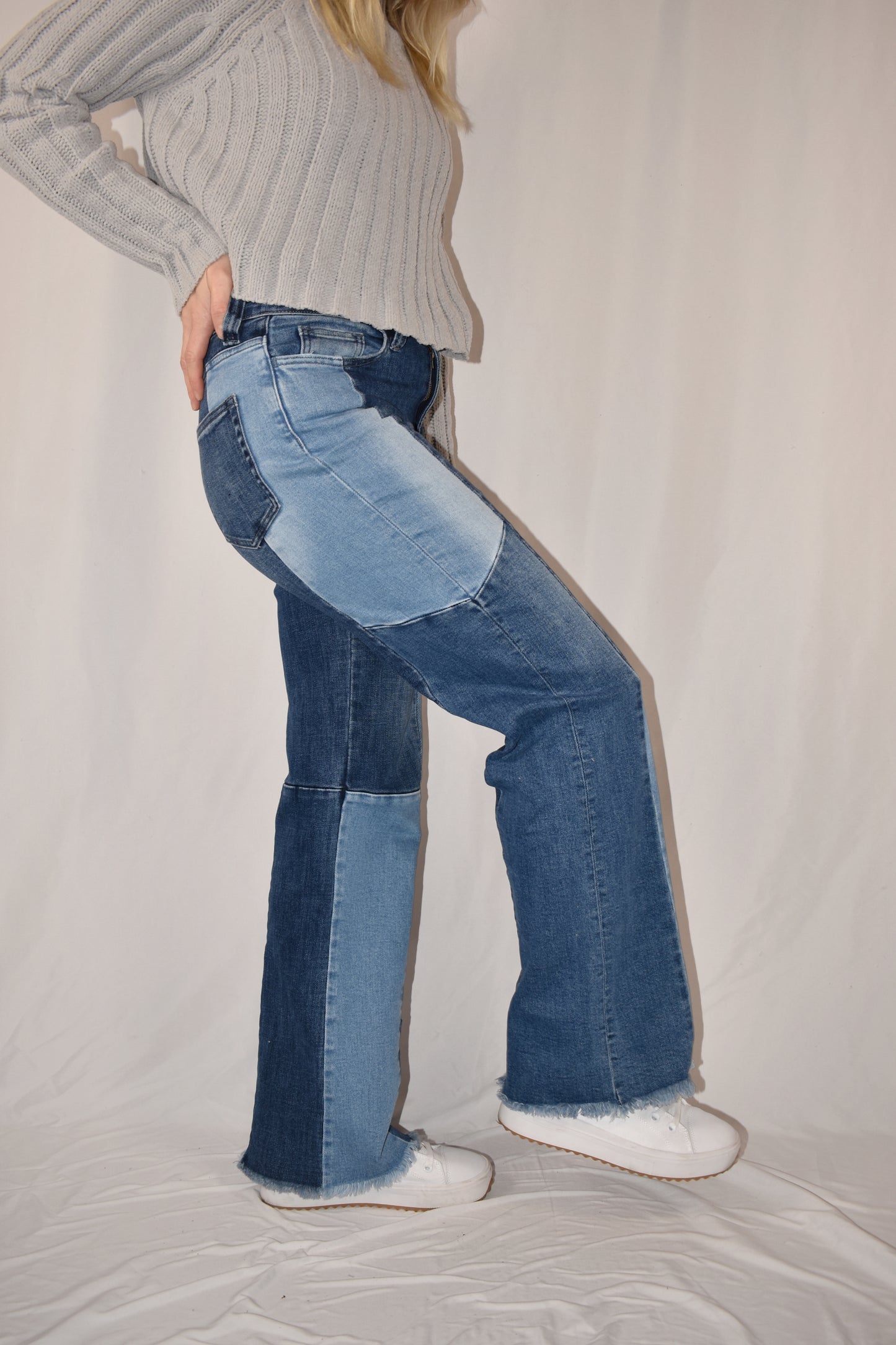 boyfriend/straight leg style jeans with stretch denim. Patchwork style ranging from medium to light wash. frayed hem, full length.