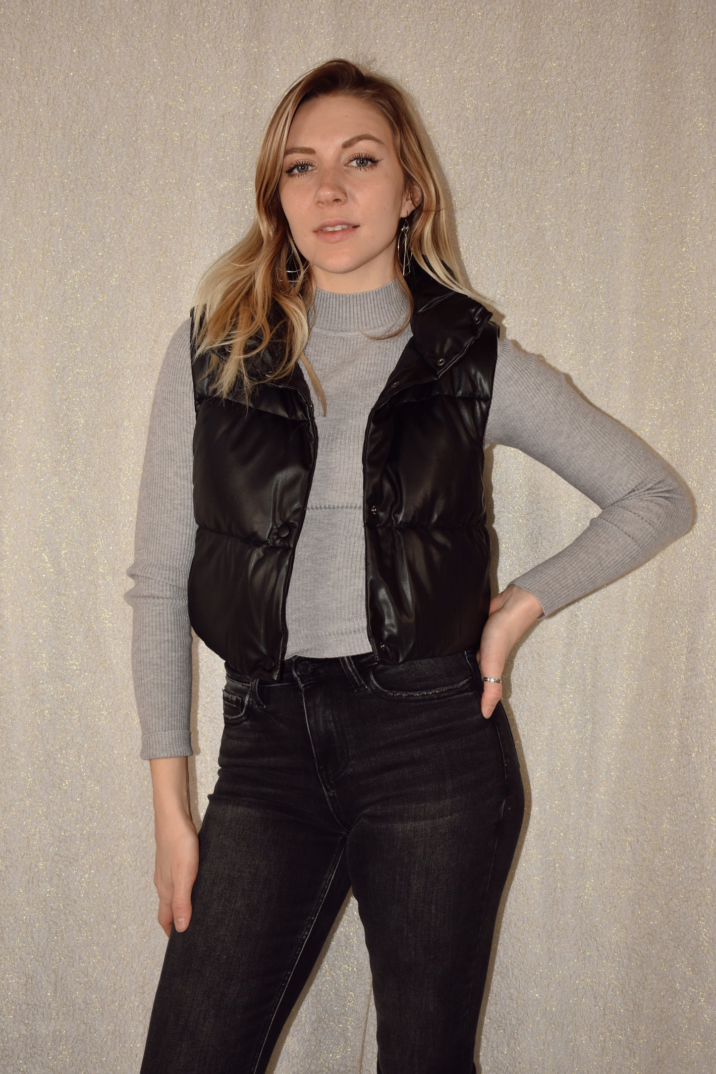 cropped faux leather puffer vest with snap enclosure and drawstrings at bottom to synch