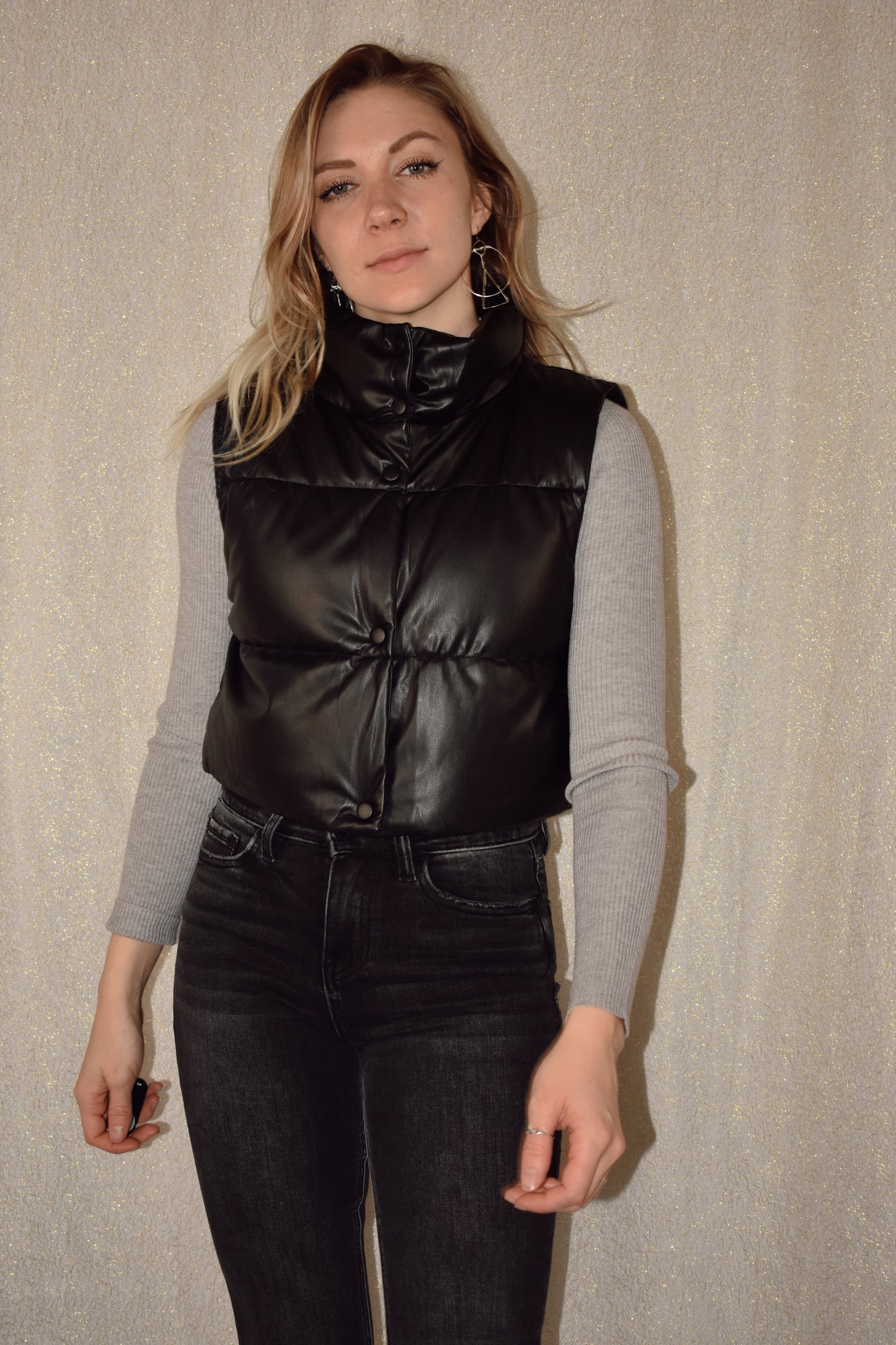 cropped faux leather puffer vest with snap enclosure and drawstrings at bottom to synch