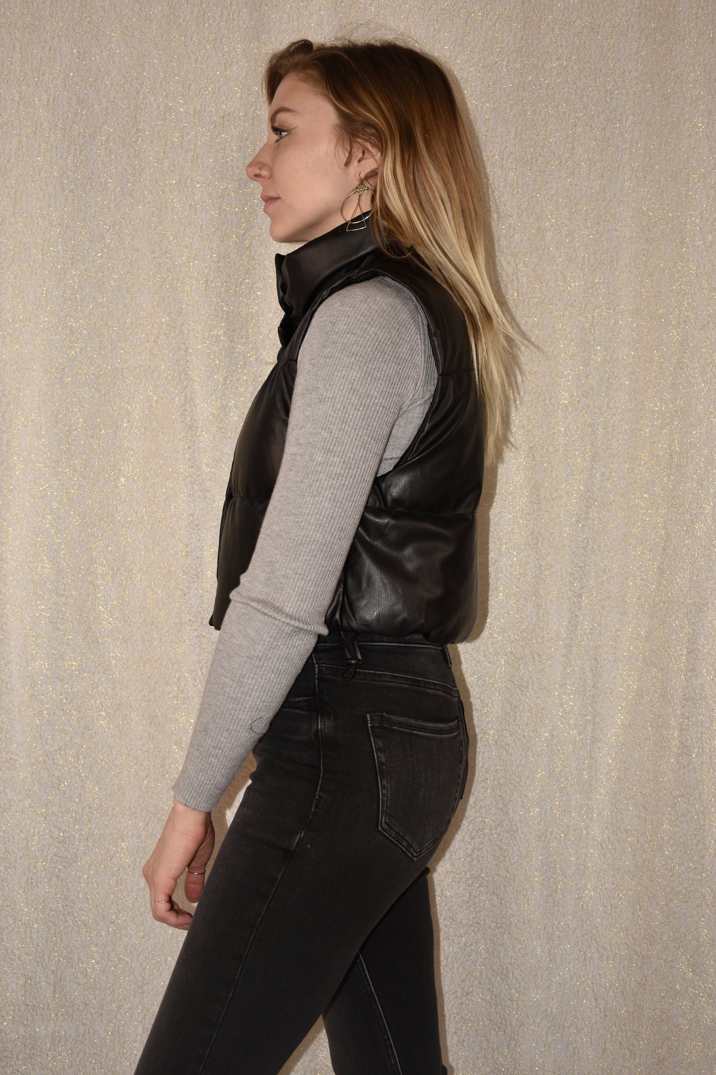 cropped faux leather puffer vest with snap enclosure and drawstrings at bottom to synch