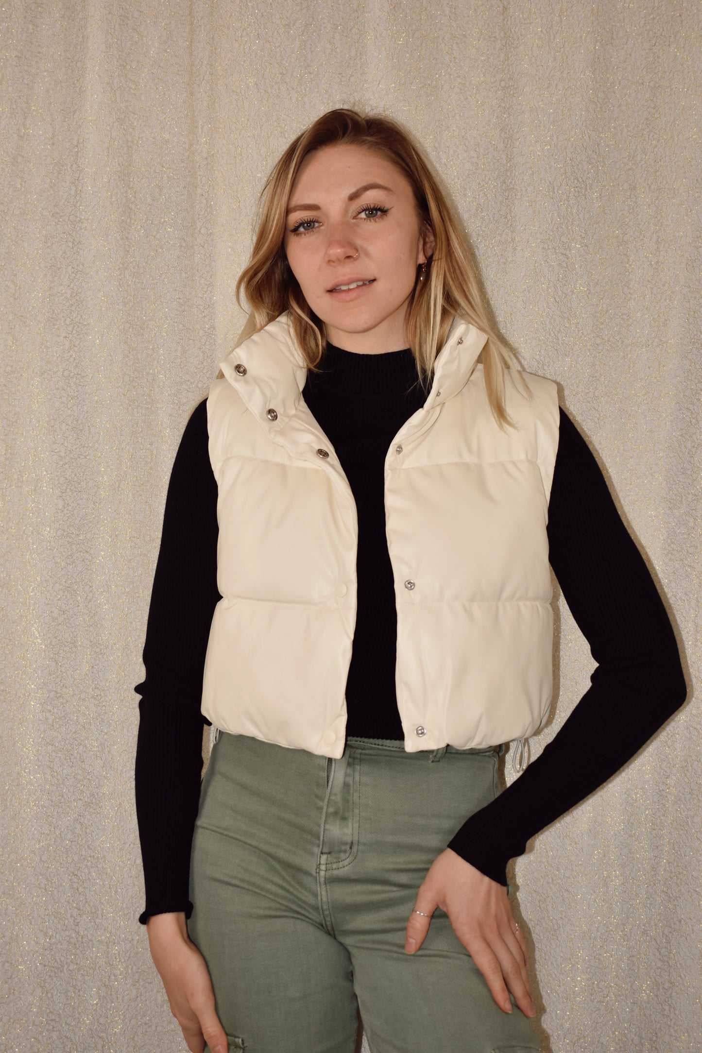 cropped faux leather puffer vest with snap enclosure and drawstrings at bottom to synch