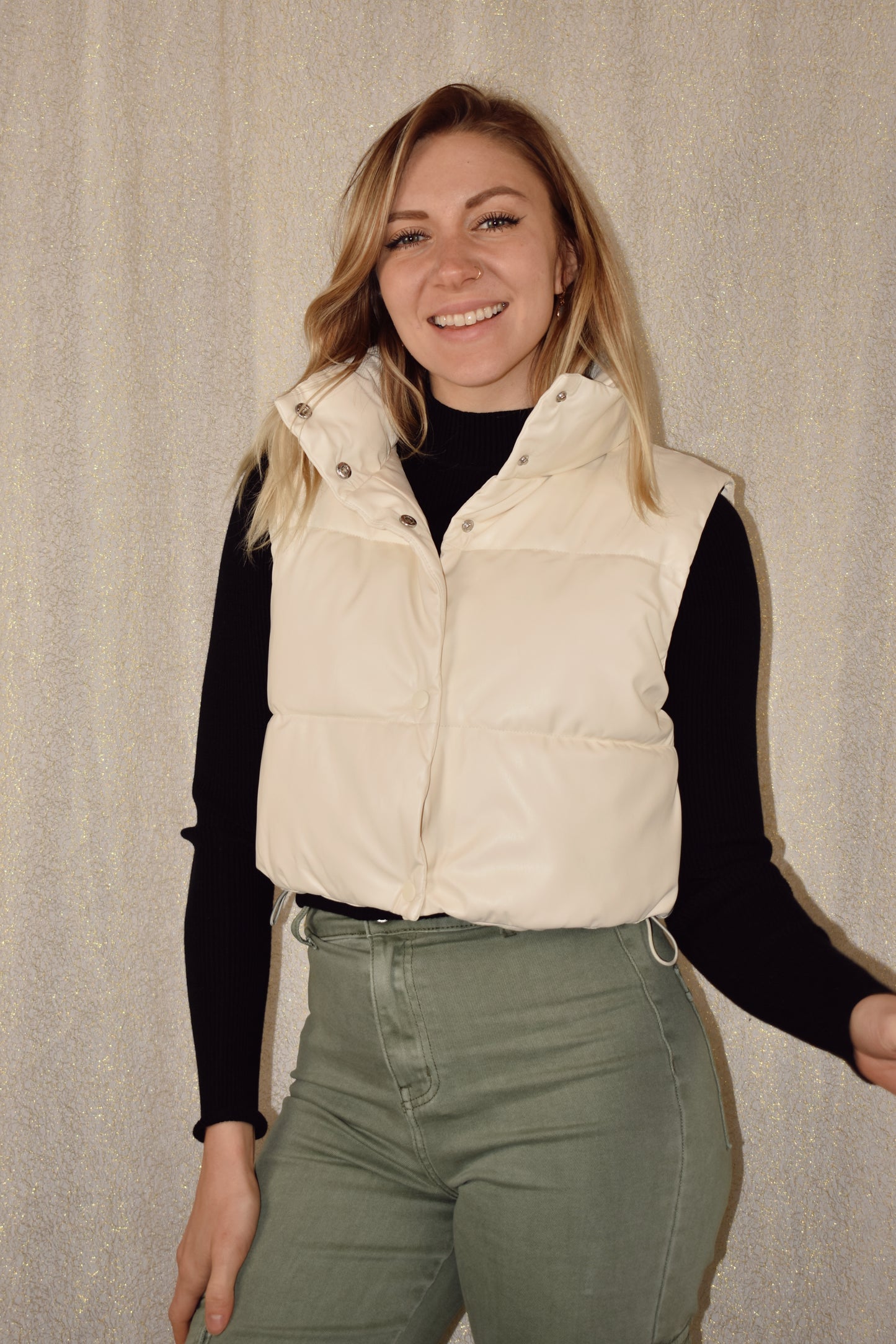cropped faux leather puffer vest with snap enclosure and drawstrings at bottom to synch