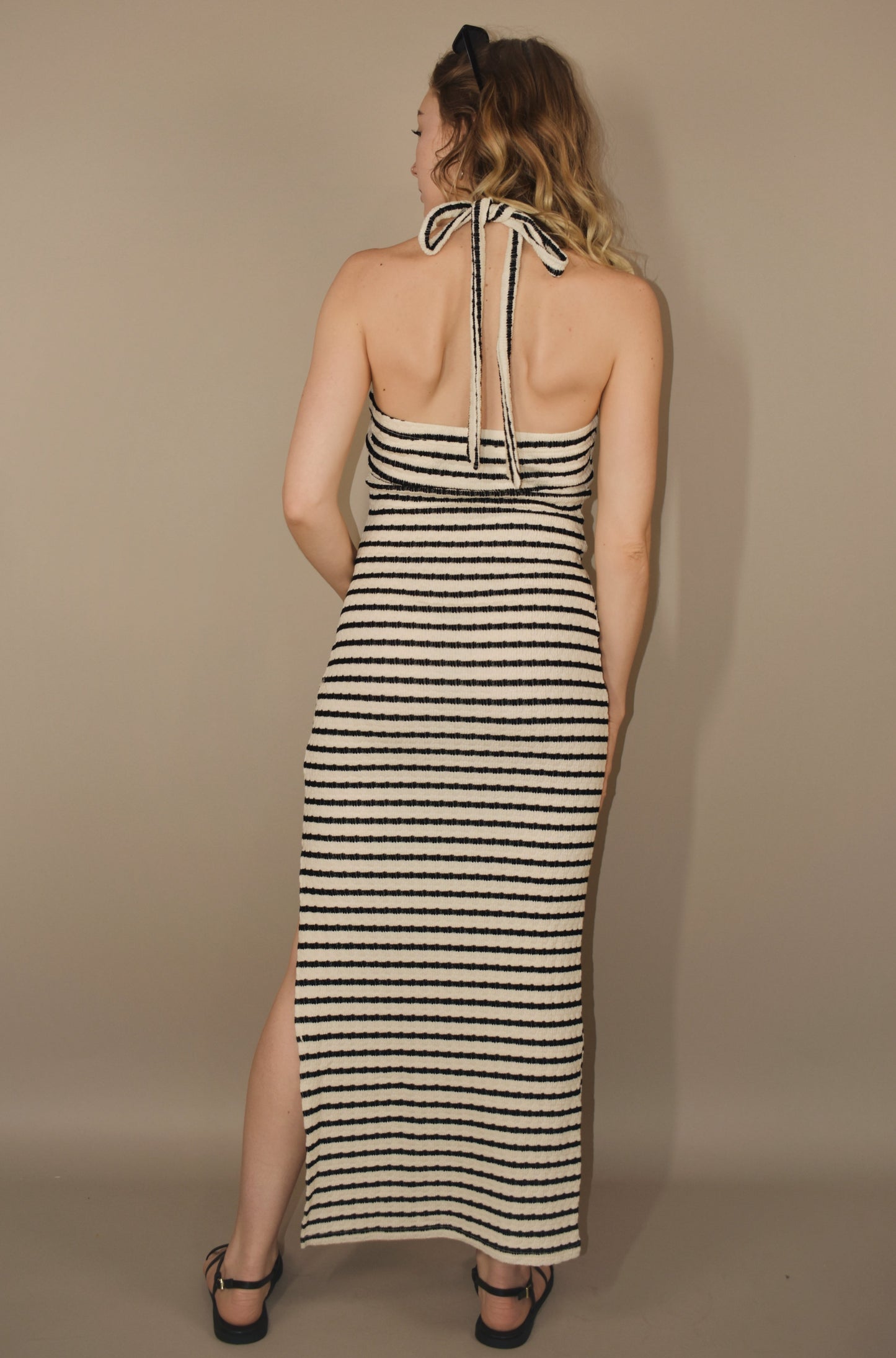 black and white striped midi dress with side slit and halter ties. twist front with triangle cut out. thick yet lightweight stretchy ribbed fabric.