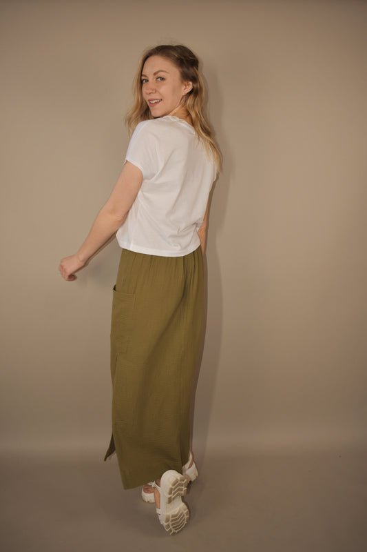 olive double gauze fabric midi skirt. side slit and patch pocket on the same side as the slit. seam down the front. drawstring waist. super soft.