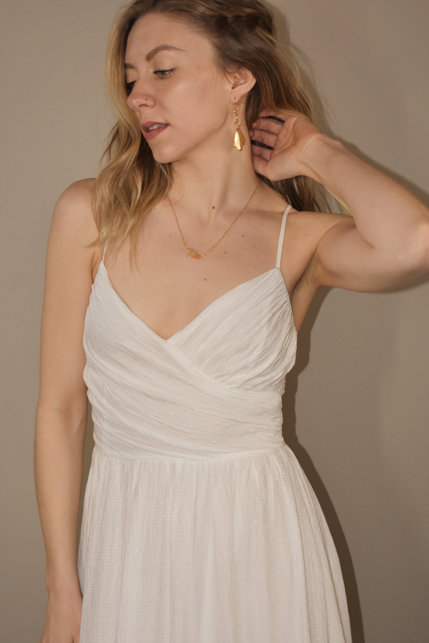 white tiered midi dress with fitted v neck wrapped bodice and smocked stretch on back. adjustable spaghetti straps. slight shimmer to fabric. delicate and flowy. bridal shower dress.
