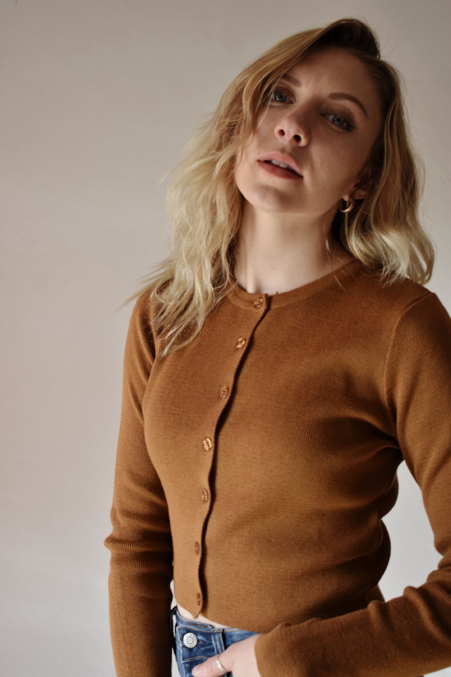 fitted ribbed knit full button cardigan. waist length crew neck when buttoned. light brown color