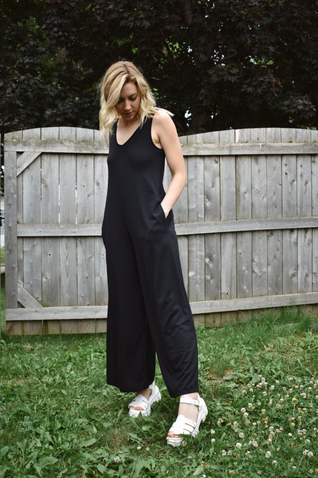 scoop neck tank jumpsuit in black with wide legs and pockets. Made with french terry knit fabric and is loose fitting. The brand is Mittoshop.