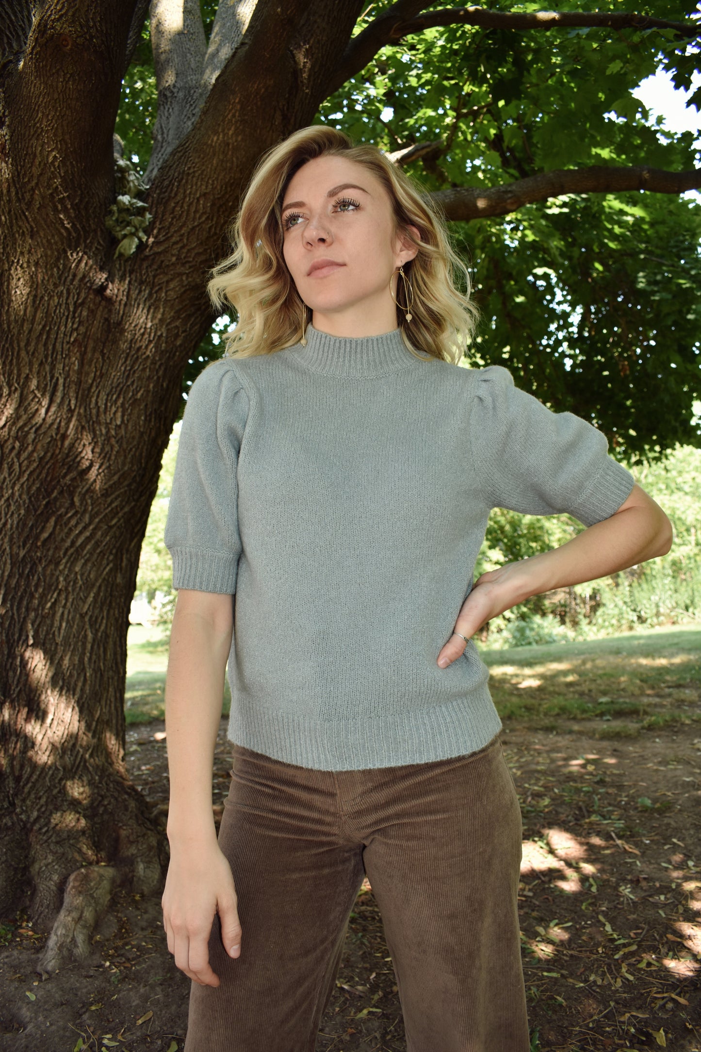 light blue mod neck short puff sleeve sweater with a tailored fit with a ribbed neck and cuffs. Sleeves hit just above the elbow.