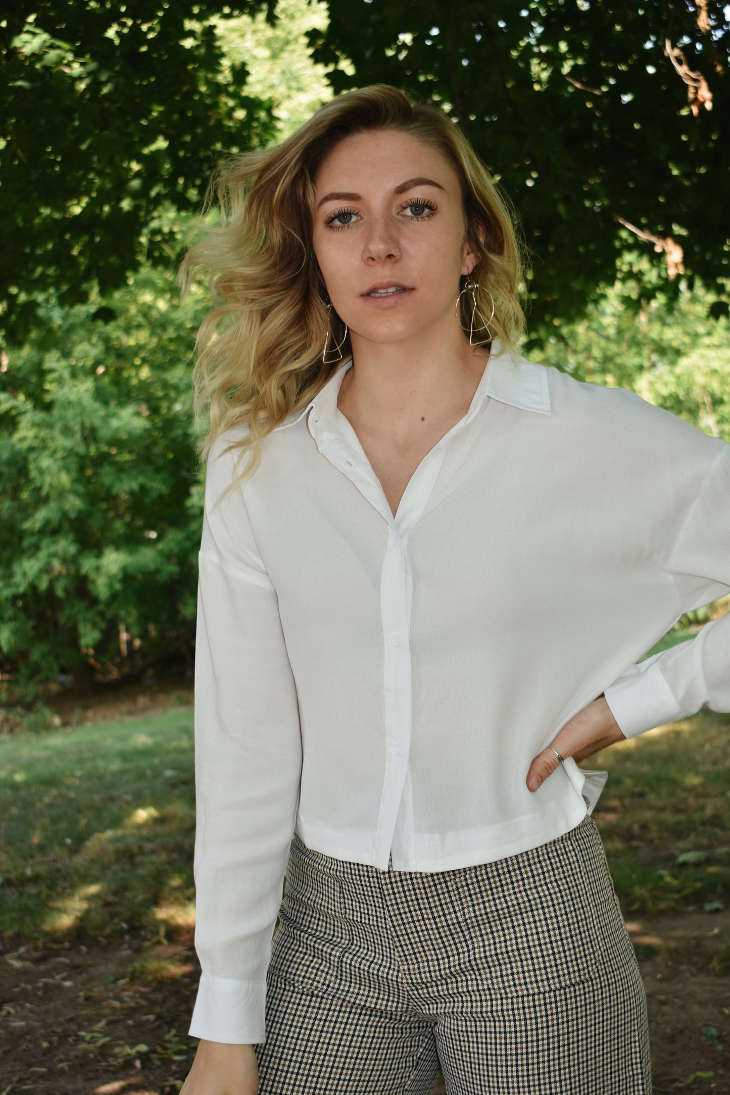 white button down top with cuffed bands and a collar. Placket front with button closure and a cropped length.