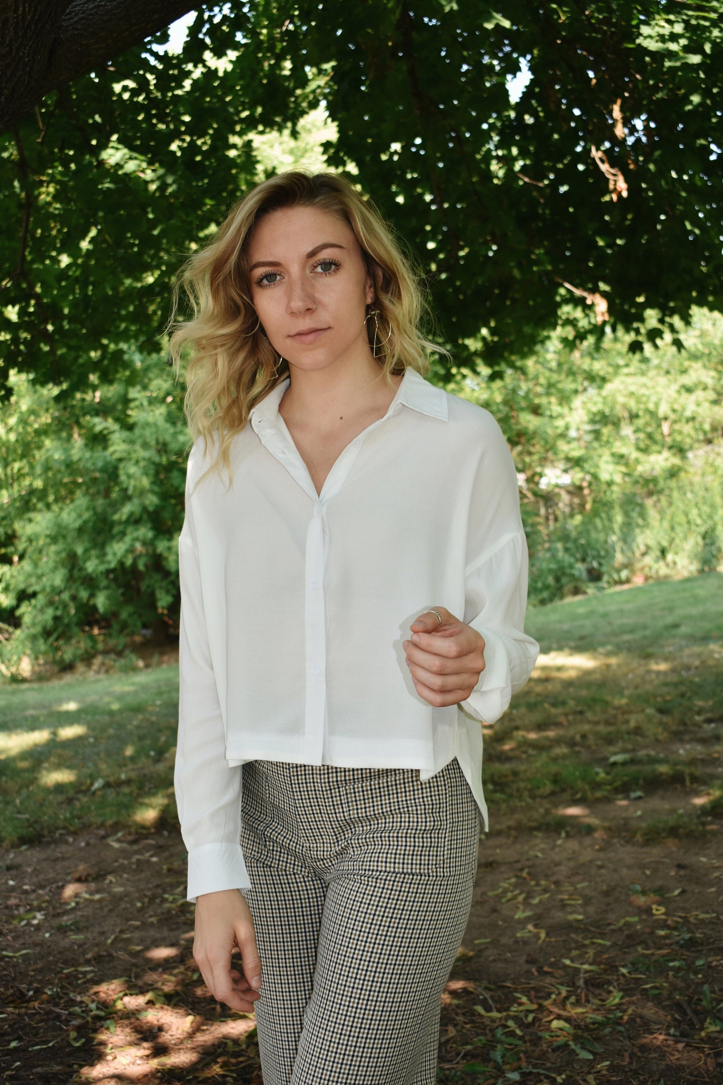 white button down top with cuffed bands and a collar. Placket front with button closure and a cropped length.