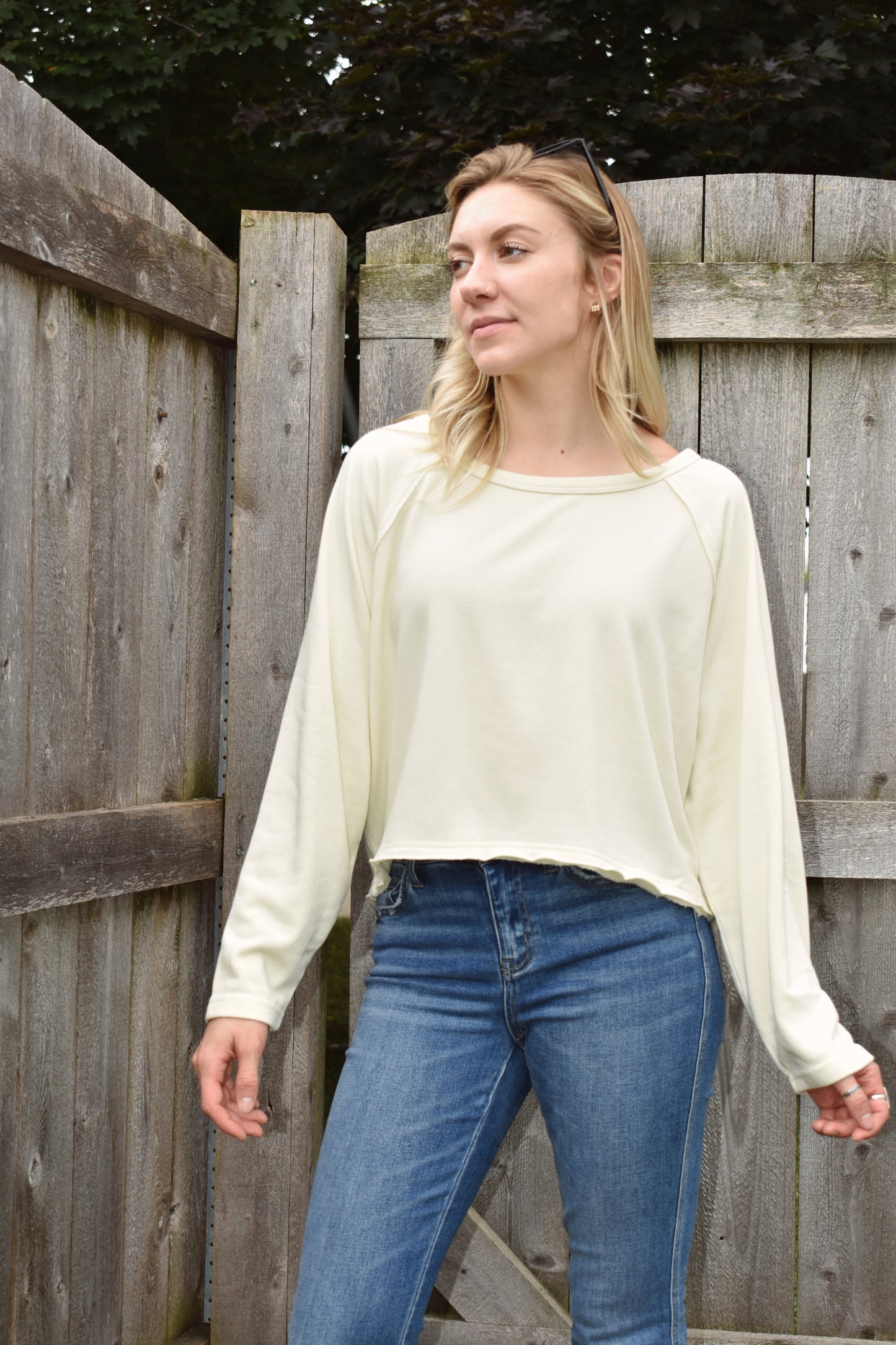 athleisure style long sleeve sweatshirt with raglan style sleeves slight acid wash boat neck and boxy fit