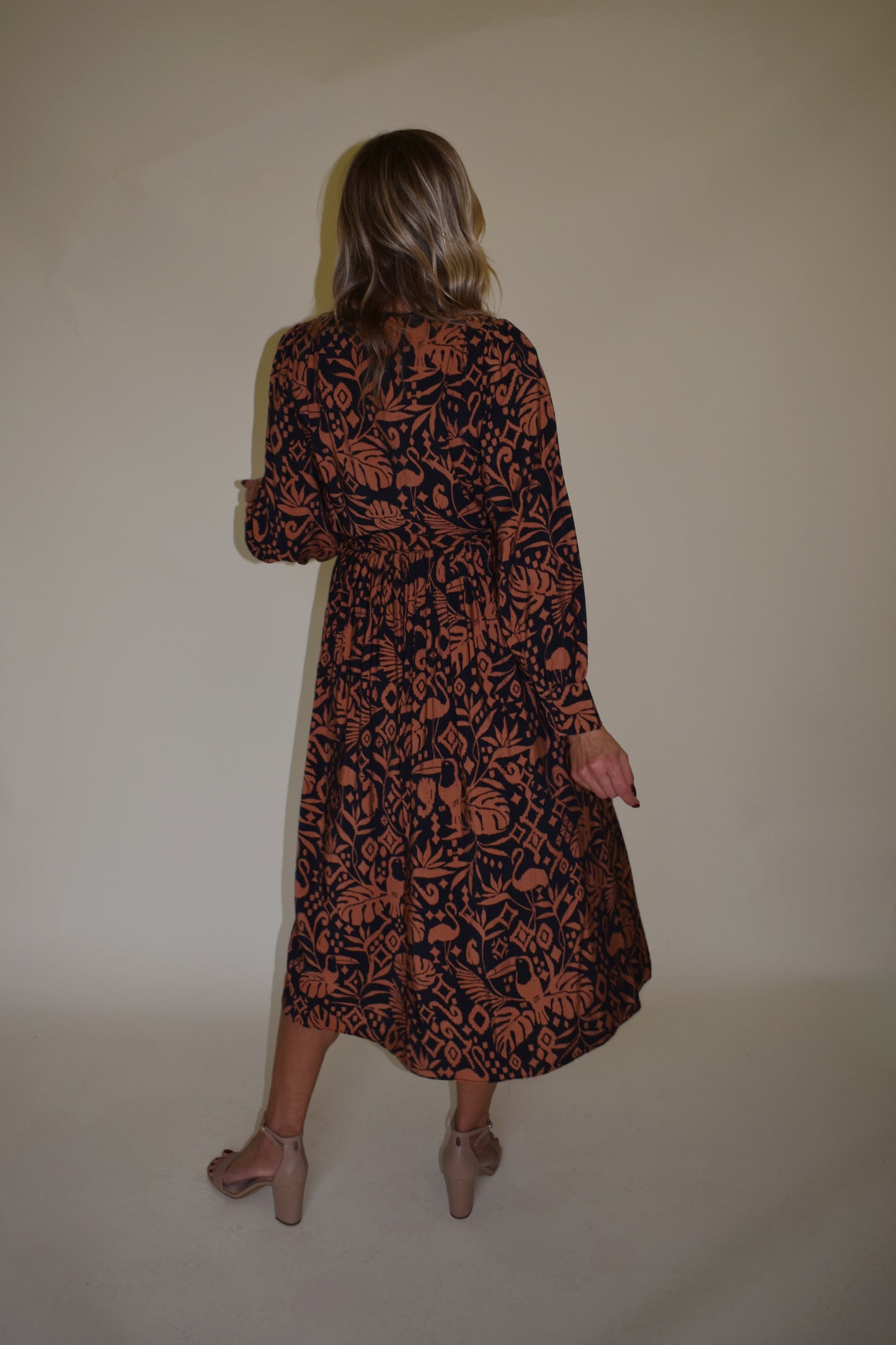 Monstera print wrap midi dress with long bishop sleeves black and clay color