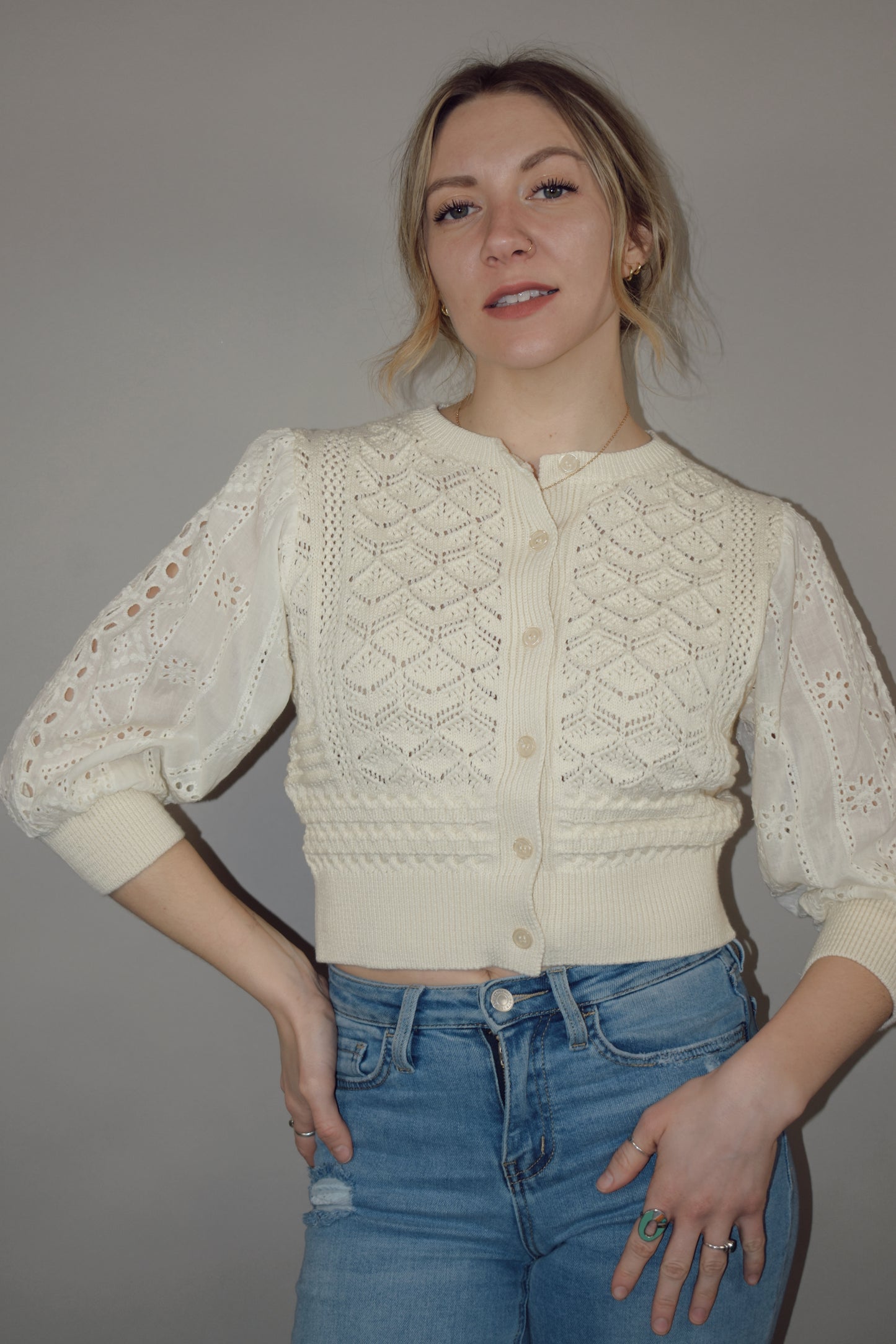 cropped button down top, round neck, 3/4 sleeves, crochet stitching on bodice, lace sleeves, knit cuffs and hem. super charming and unique