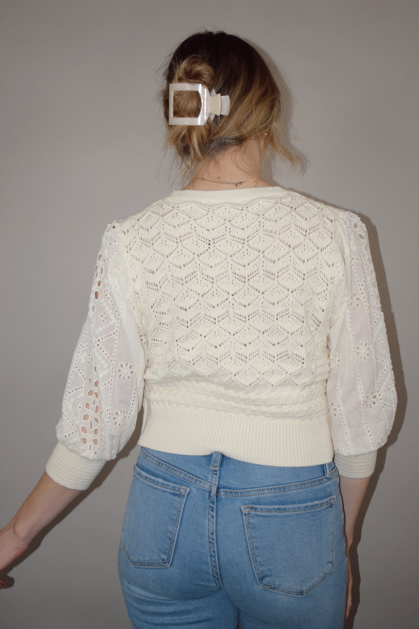 cropped button down top, round neck, 3/4 sleeves, crochet stitching on bodice, lace sleeves, knit cuffs and hem. super charming and unique