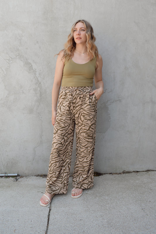 zebra print linen blend pants with relaxed wide leg fit, high rise with elastic waist and drawstring, front patch pockets and fake back pocket slits, full length