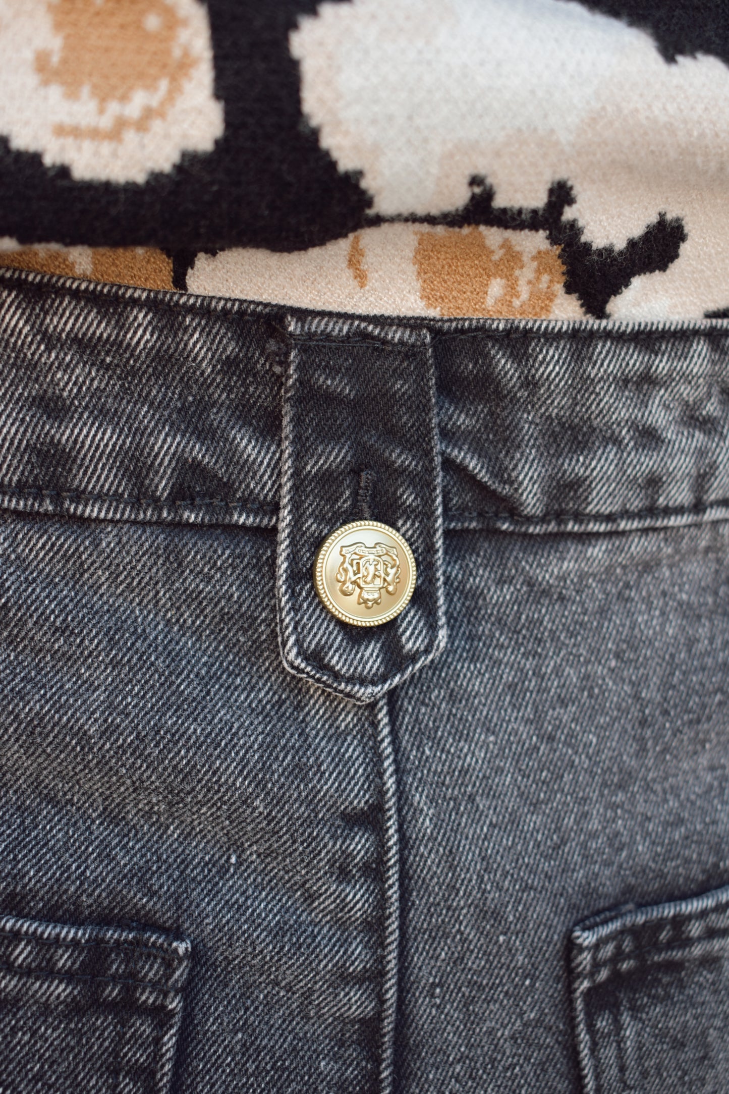 wide leg jeans - black wash - no holes - gold sailor buttons along front side pockets and on button on back belt loop fastening it. zip and button enclosure. high waisted.