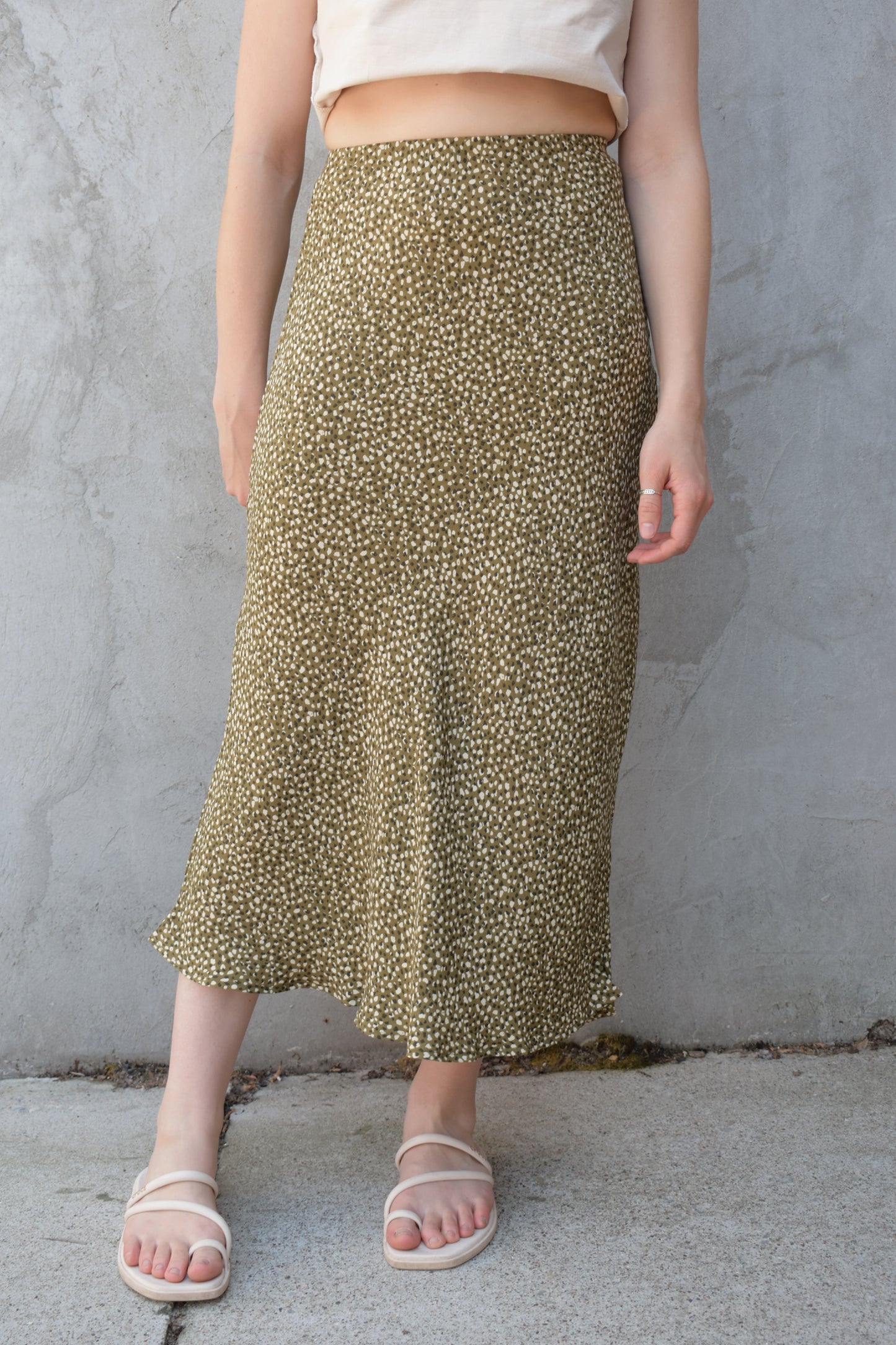 lightweight midi skirt with elastic waistband, no pockets, olive green background with black and cream dotted pattern