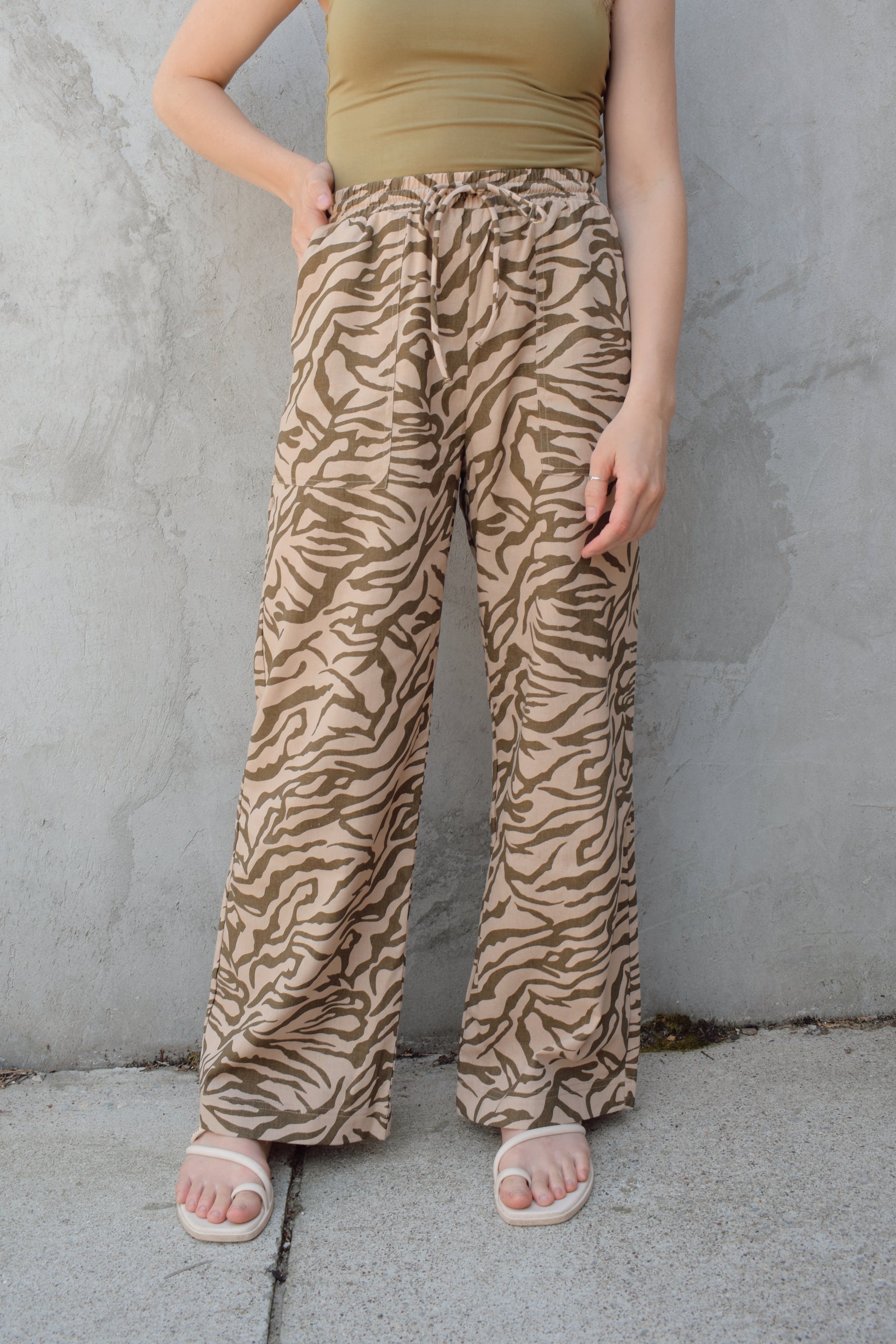 zebra print linen blend pants with relaxed wide leg fit, high rise with elastic waist and drawstring, front patch pockets and fake back pocket slits, full length