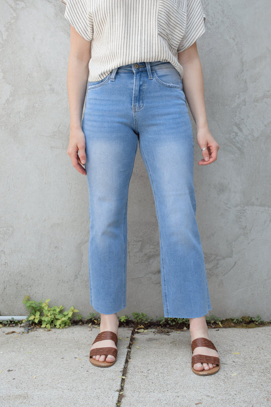 light wash slim wide leg cropped stretch denim with a raw hem and zip and button enclosure has beltloops and front and back pockets, no holes