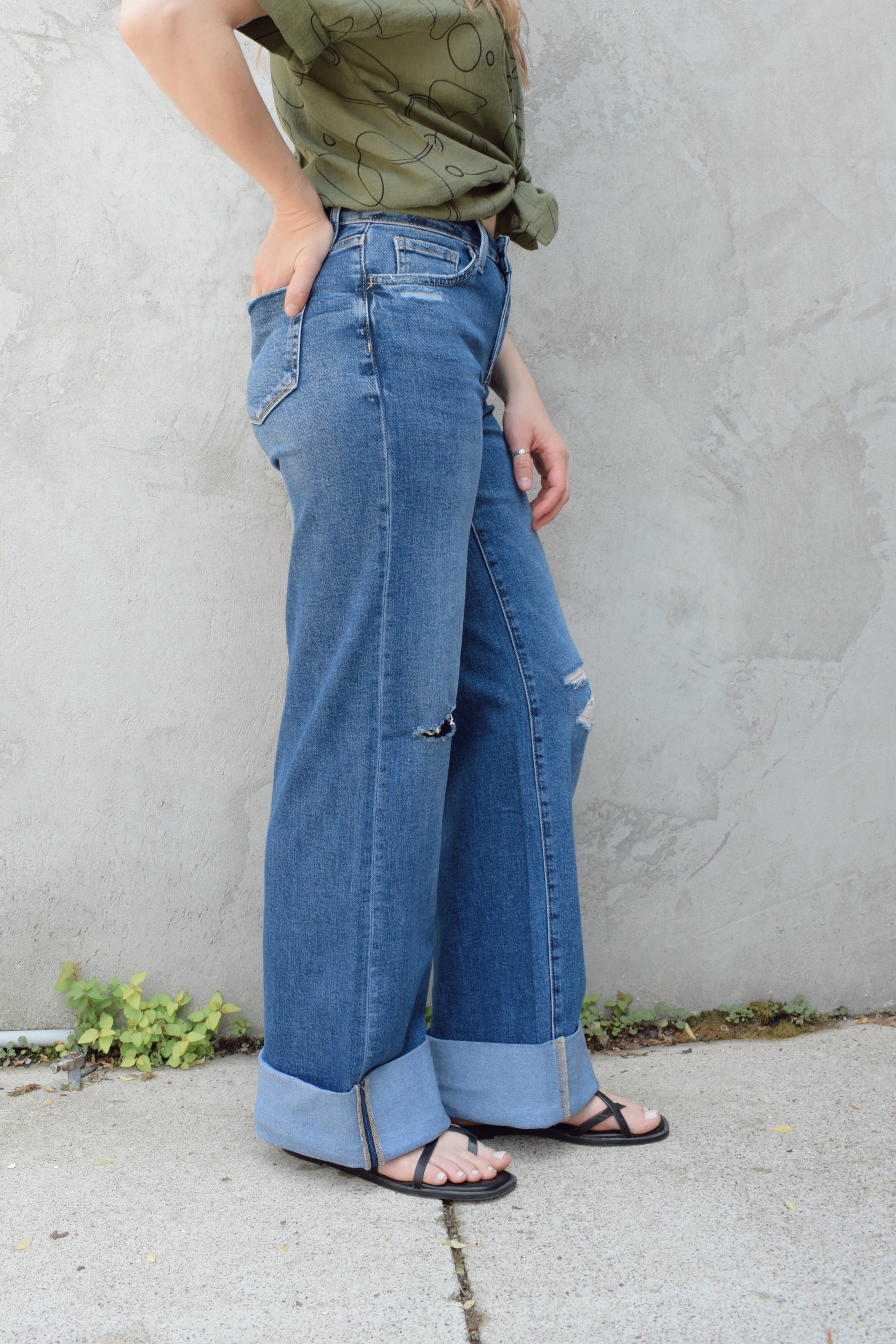 wide leg wide cuff at hem stretch denim jeans with holes in both knees, full length, dark wash, zip and button enclosure