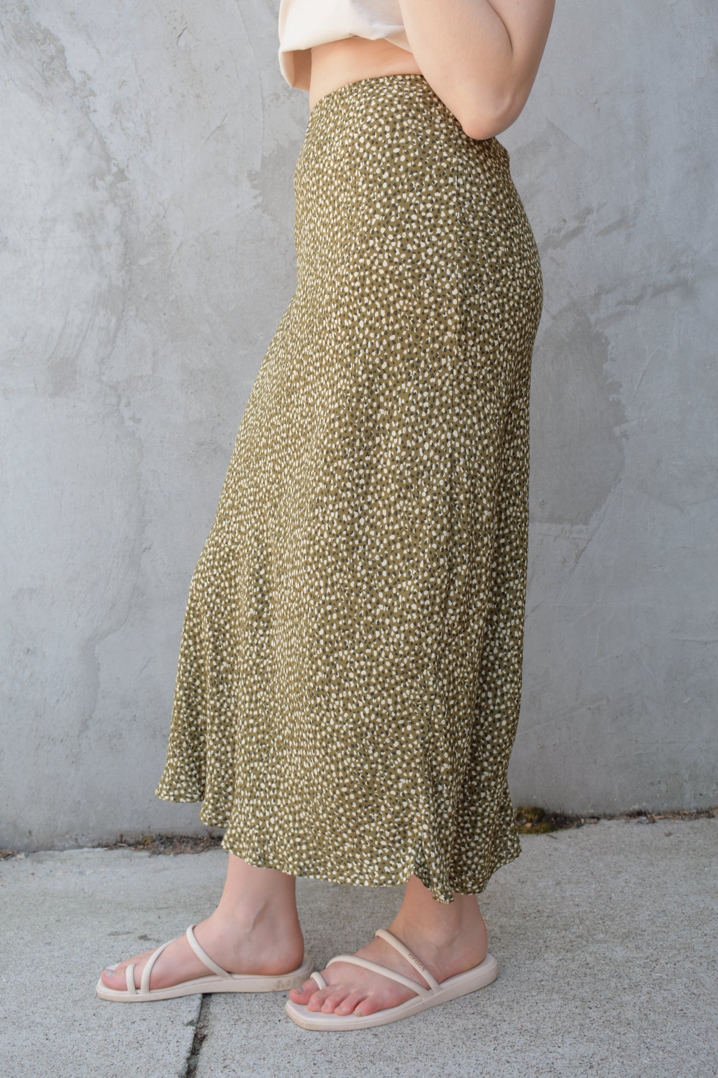 lightweight midi skirt with elastic waistband, no pockets, olive green background with black and cream dotted pattern