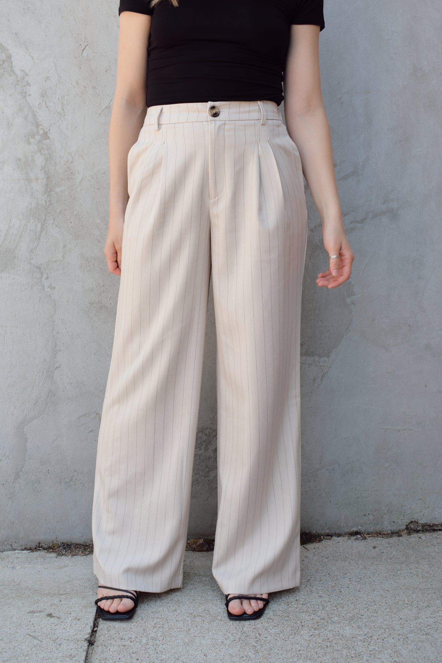 vertical pinstripe trousers with front pleats, pockets, zip and button enclosure, has beltloops, fake back pockets, elastic on back of waistband, full length