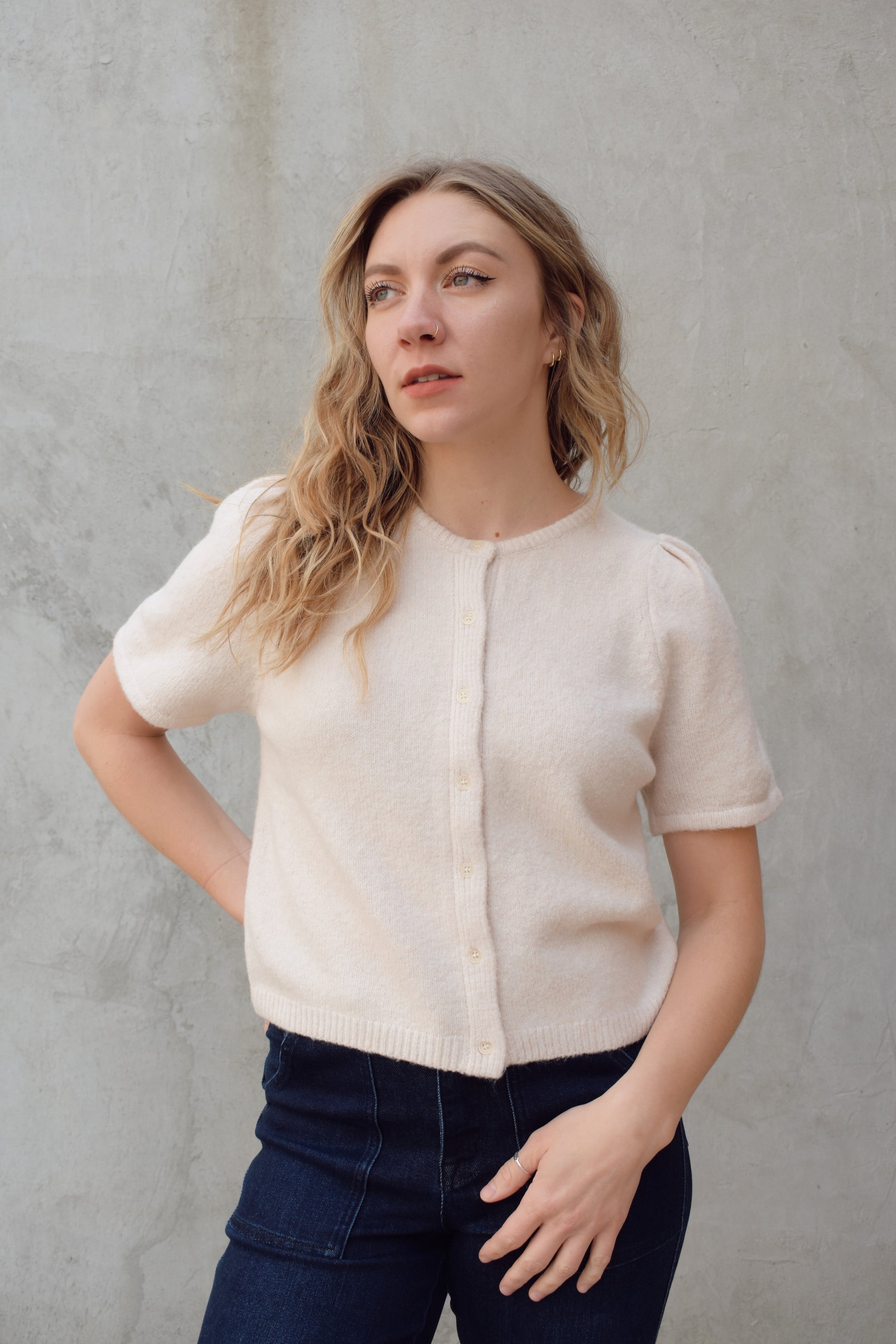 short sleeve cardigan sweater with crew neckline and slight puff sleeves gathered at shoulder, ribbed hem, straight fit, hits at waistline