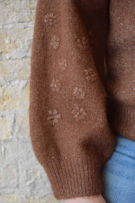 brown crew neck sweater with 3d floral design on sleeves full length ribbed collar cuffs and hem relaxed fit